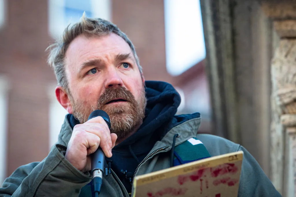 Graham Cunningham Platner speaking into a microphone.