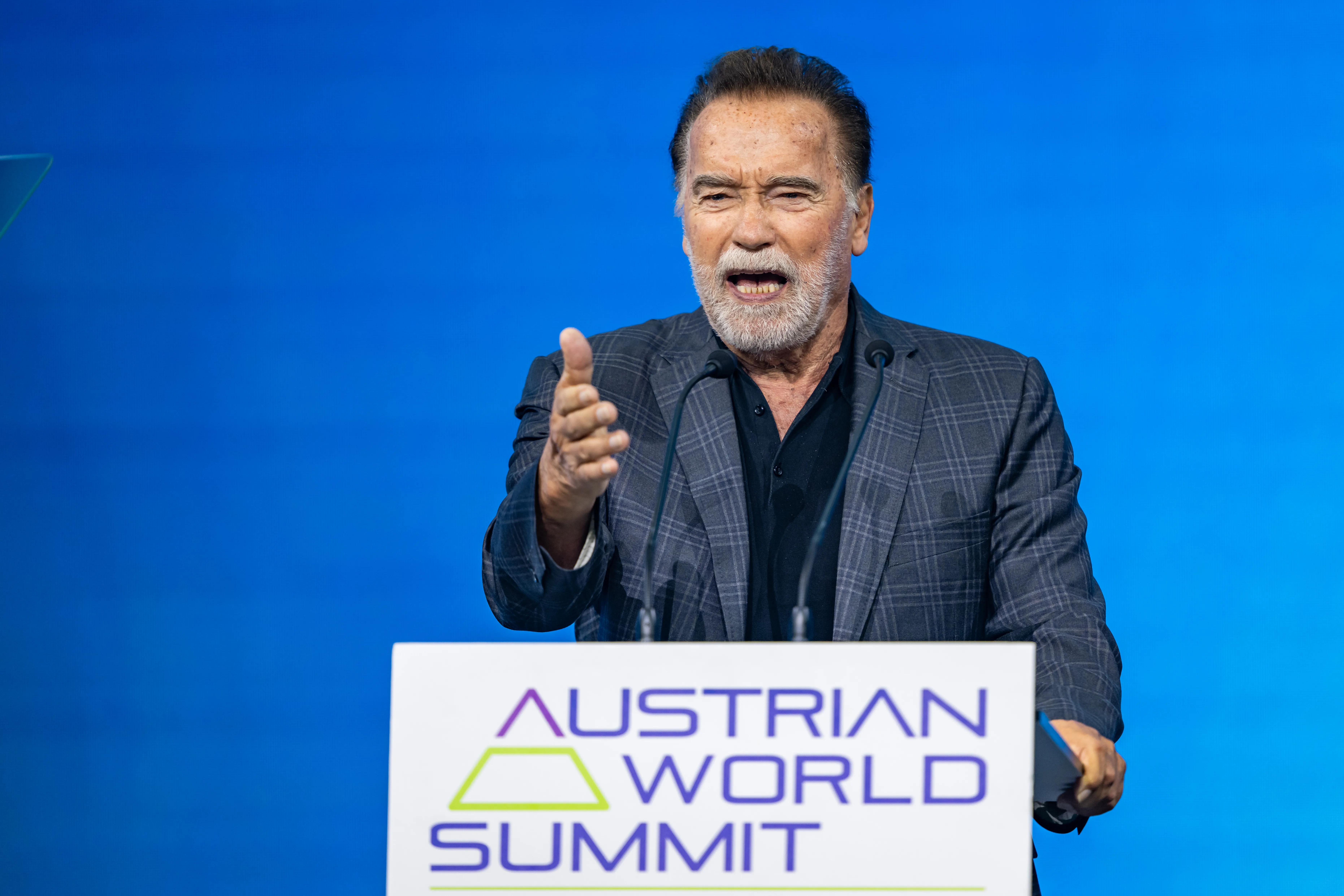 Arnold Schwarzenegger giving a keynote speech at the Austrian World Summit.