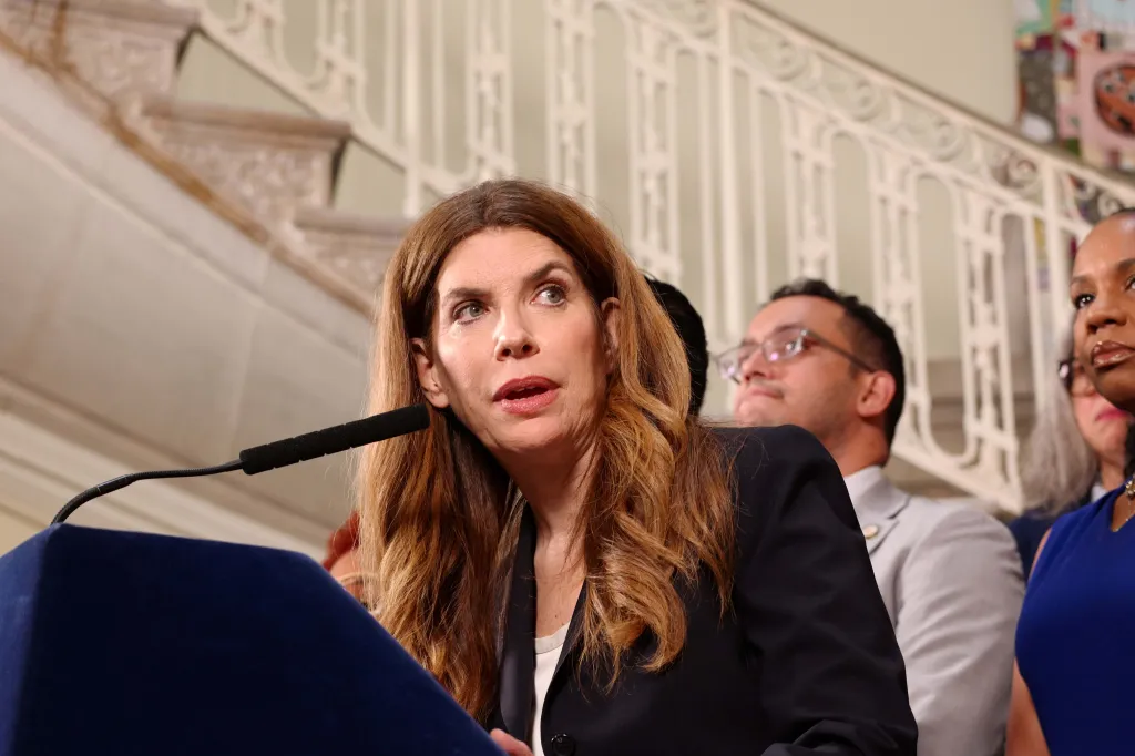 Woman speaking at a press conference regarding New York's balanced fiscal year budget.