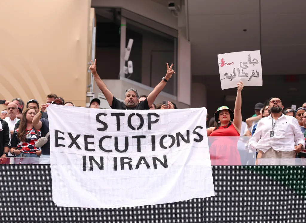 Fans holds the banner reading 'Stop Execution in Iran' before the FIFA World Cup 2026 Group G match between Belgium and IR Iran at Los Angeles Stadium on June 21, 2026 in Inglewood, California.