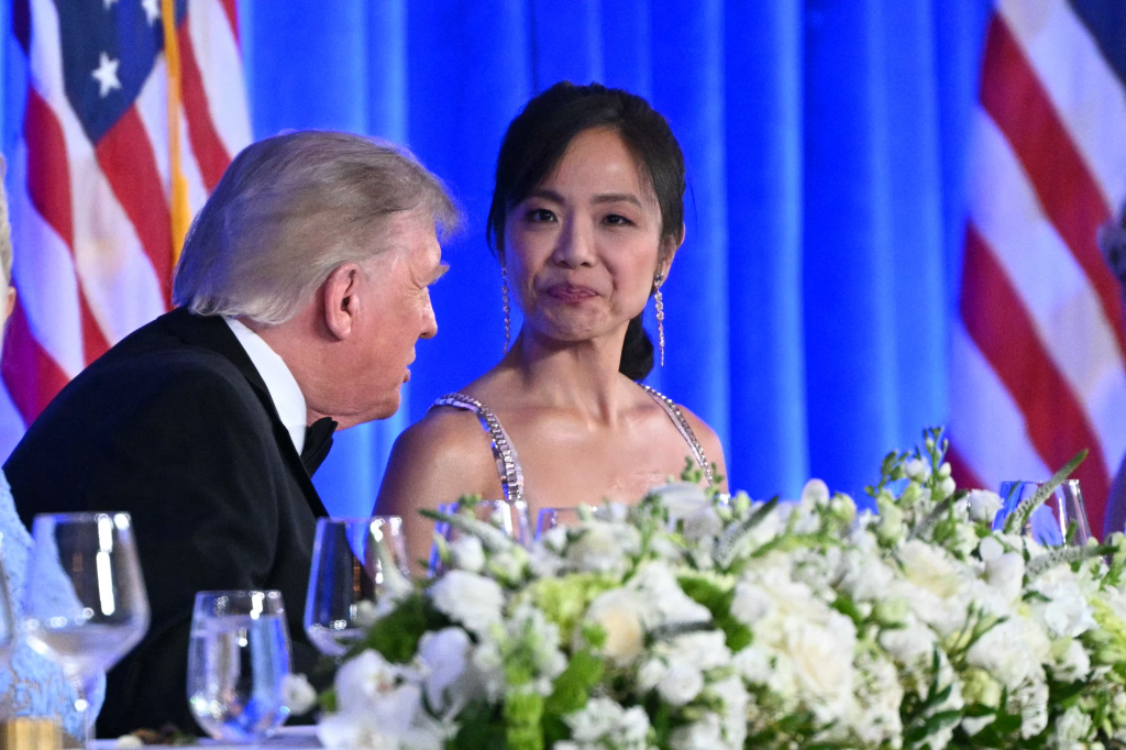 Donald Trump speaking to a woman in a formal setting.