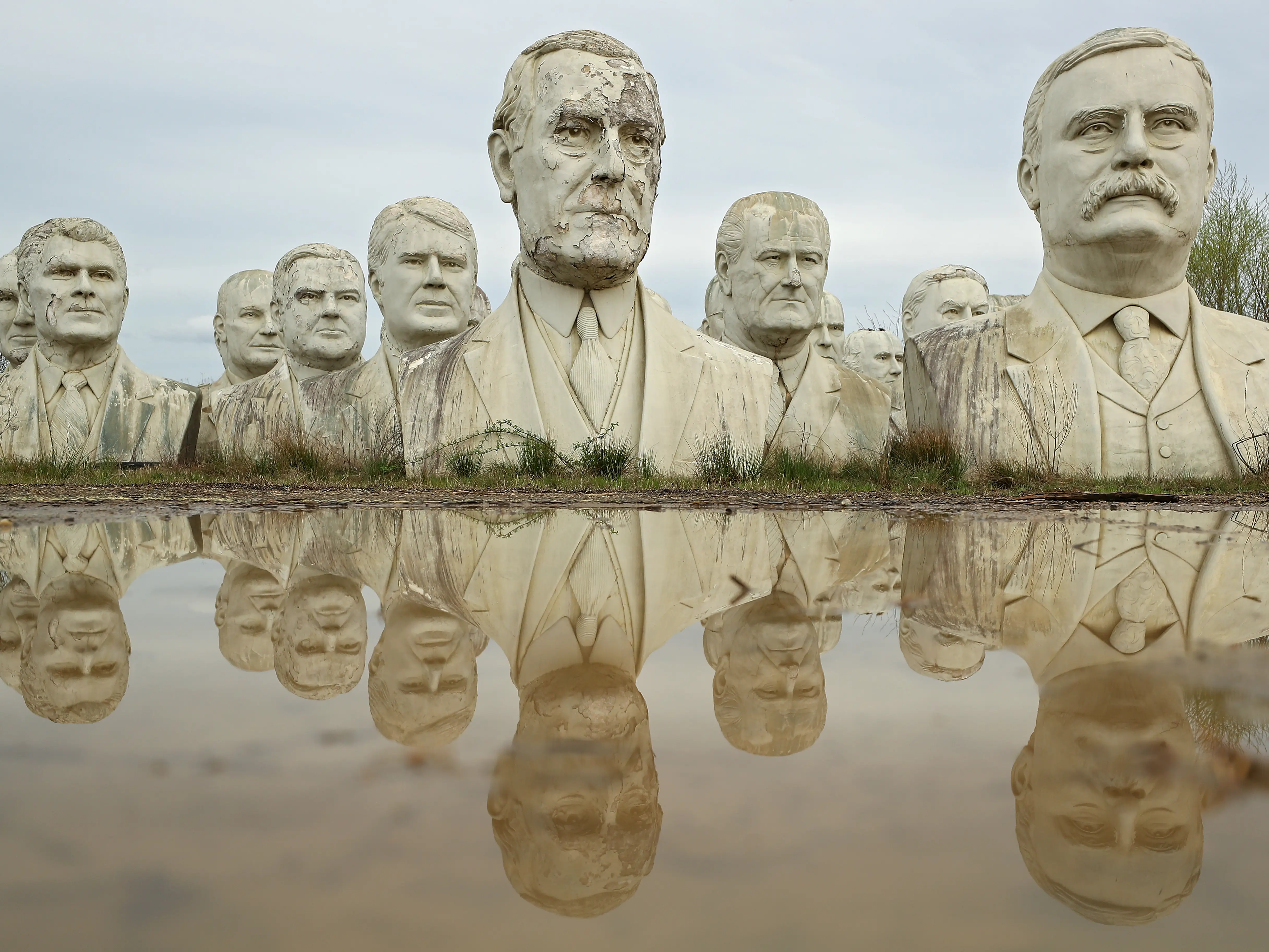 The statues's reflection in a muddy pool.