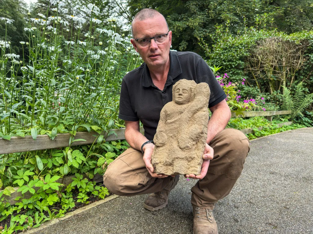 Archaeologist Dr. Andrew Birley holding a Roman 