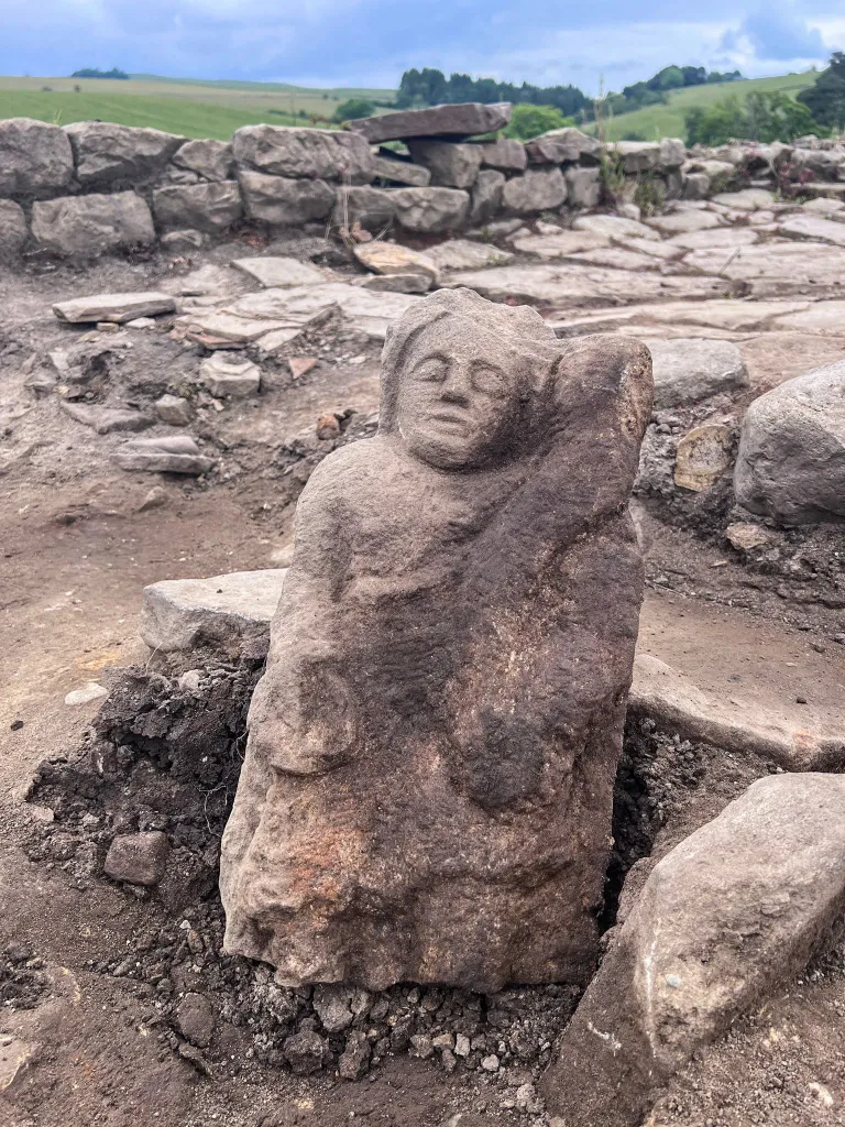 A 1.5-foot-high Roman sandstone statue of a protective spirit with a melancholic expression, found at Vindolanda Fort near Hadrian's Wall.