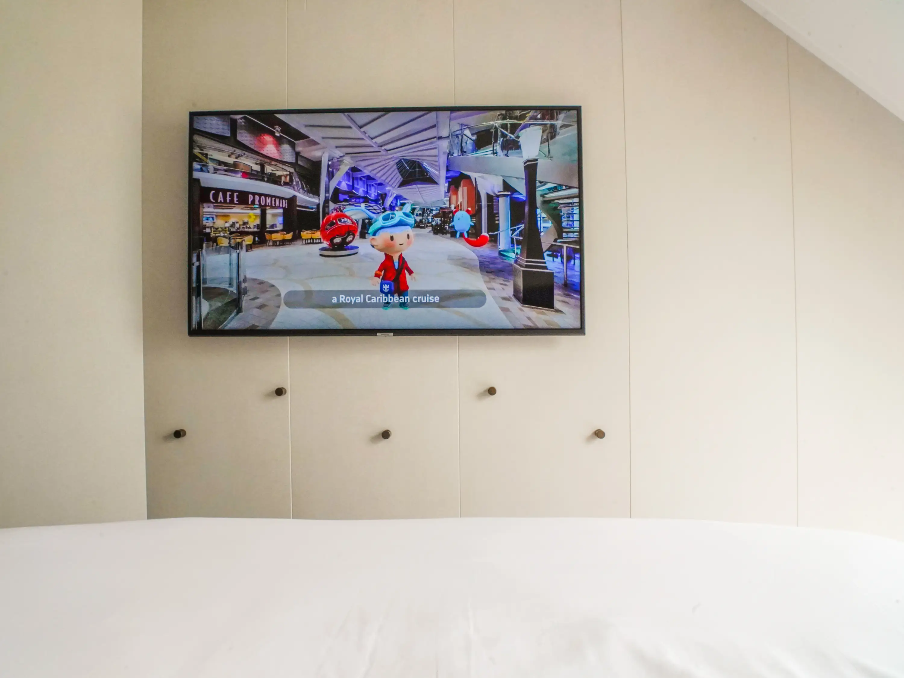 A mounted TV on a white wall
