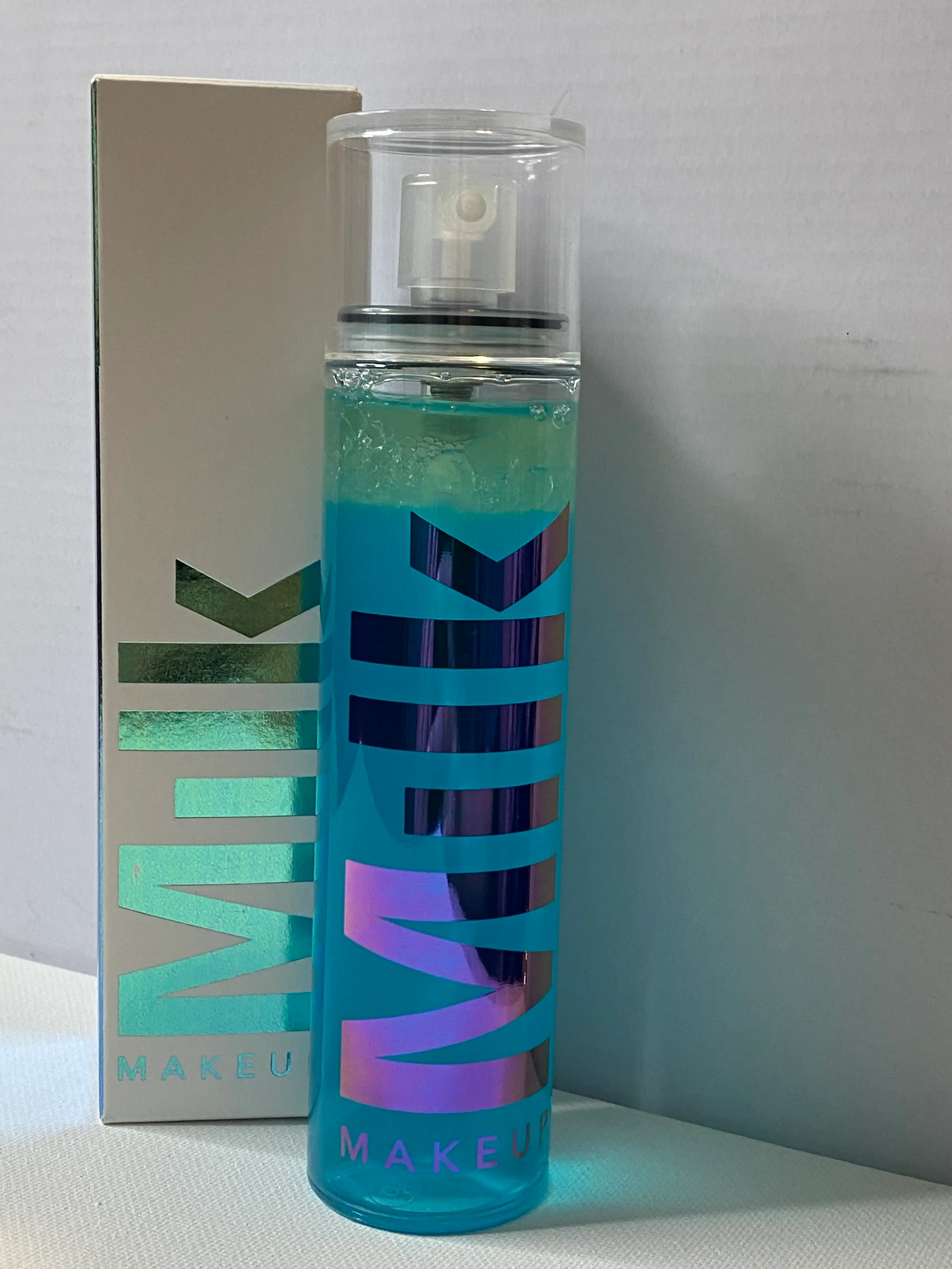 A blue spray bottle of with iridescent 