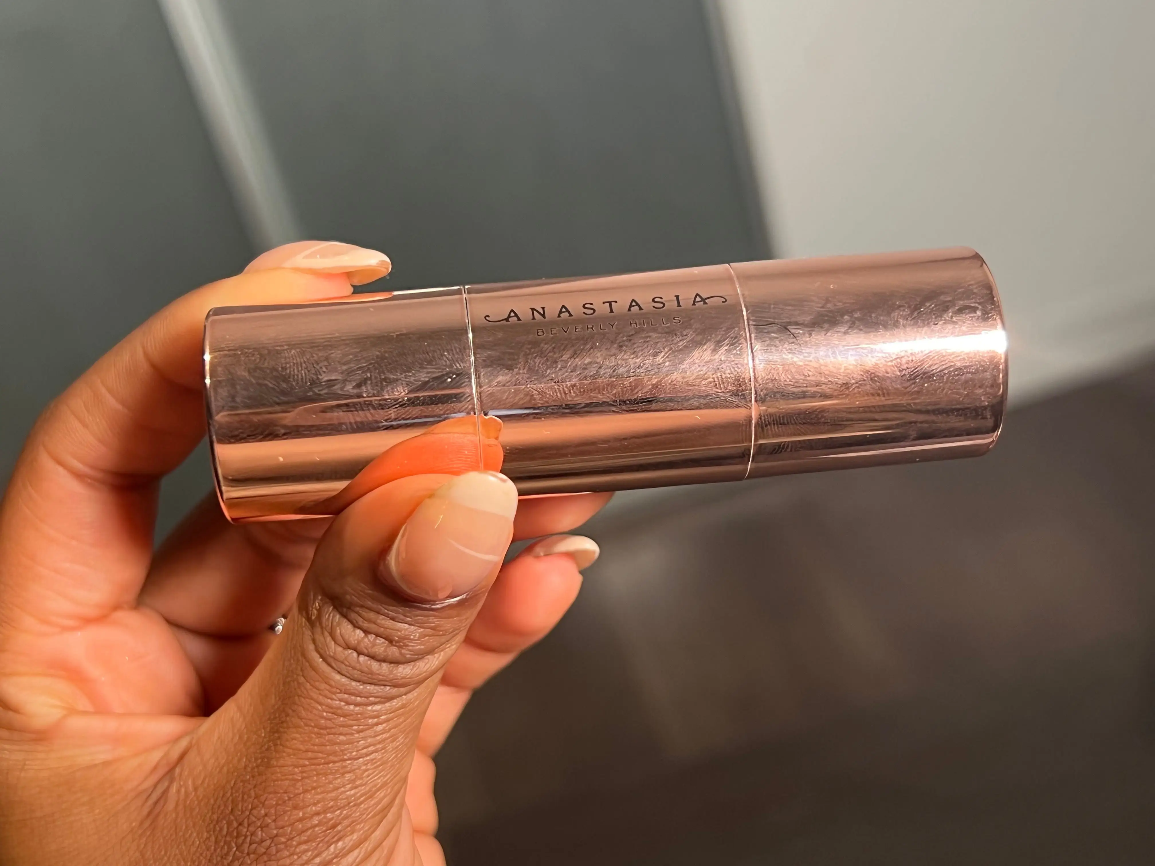 The writer holds a gold tube with
