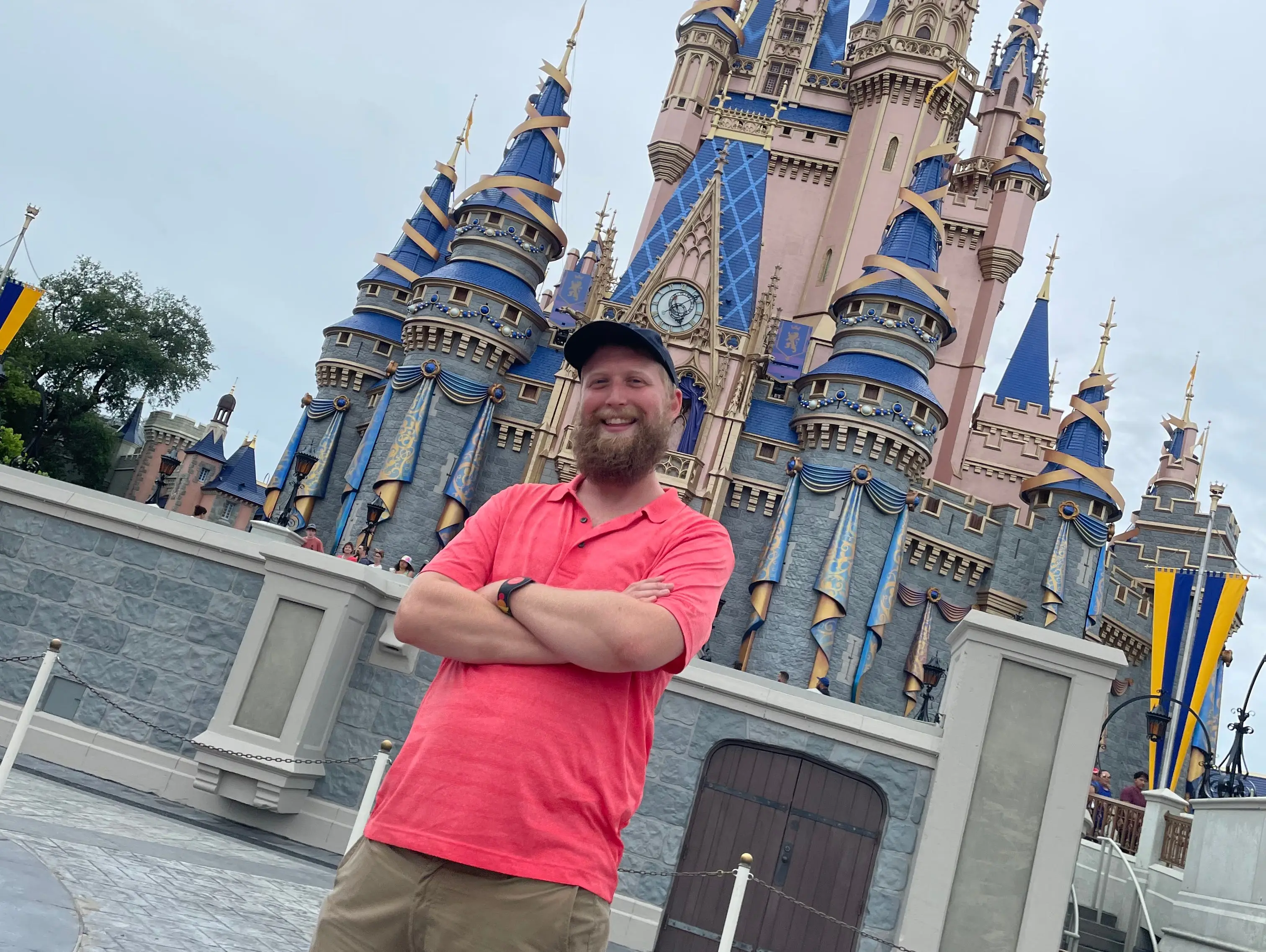 timothy posing in front of cinderella castle at disney world