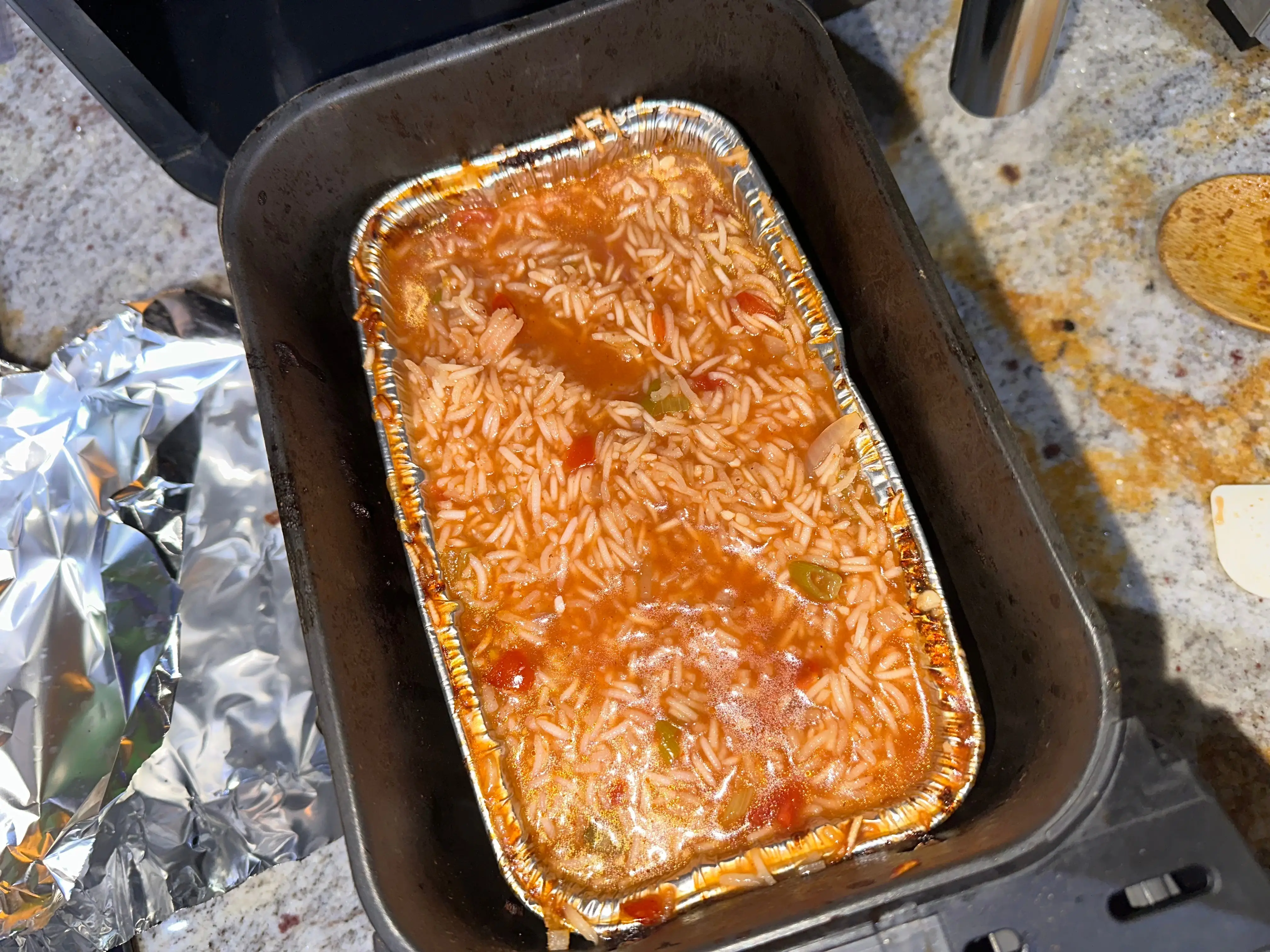 Rice with vegetables in an air fryer basket.