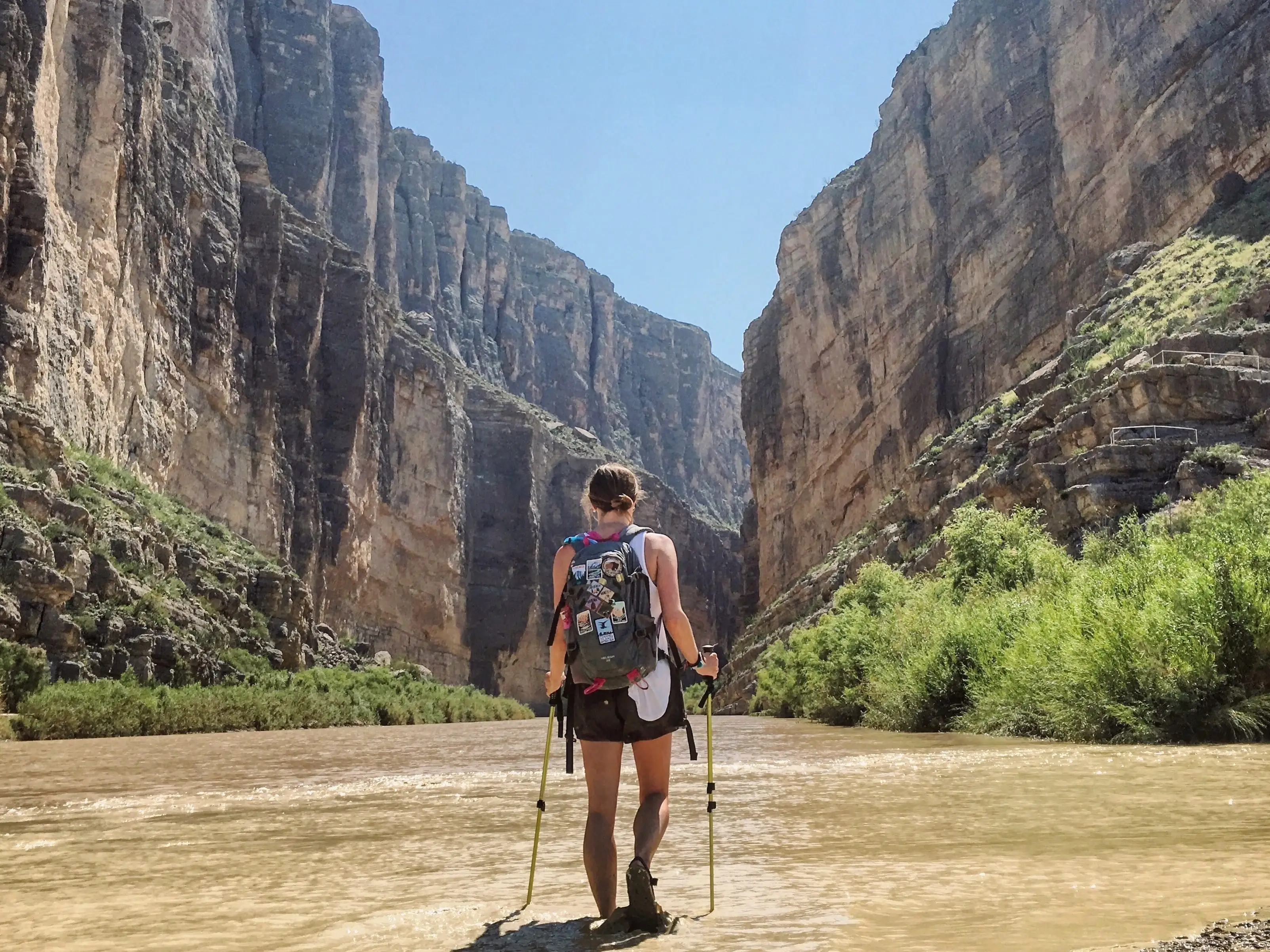 A woman with a backpack hiking in Big Bend National Park.