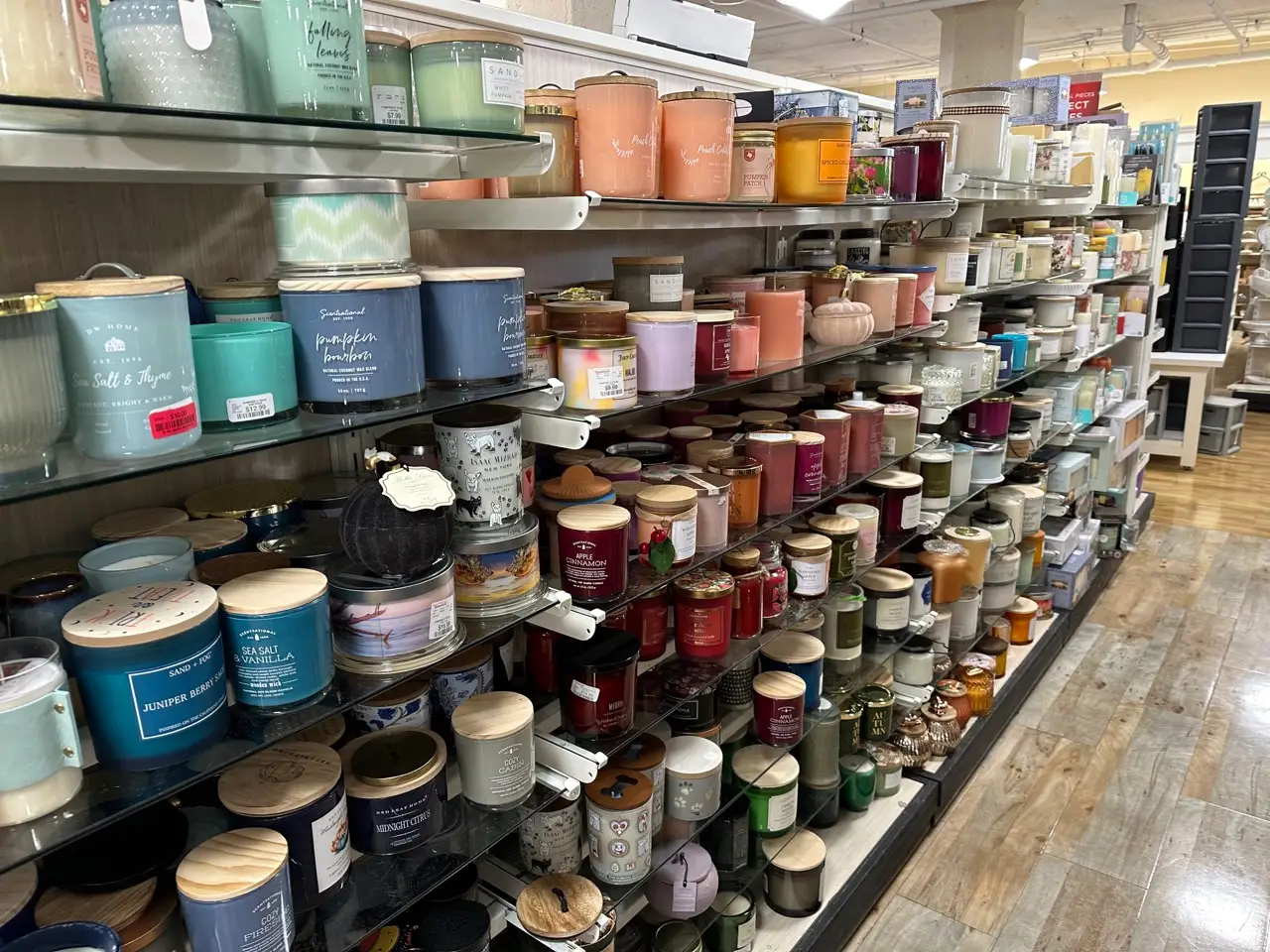 Aisle of candles in different colors and sizes in a HomeGoods location