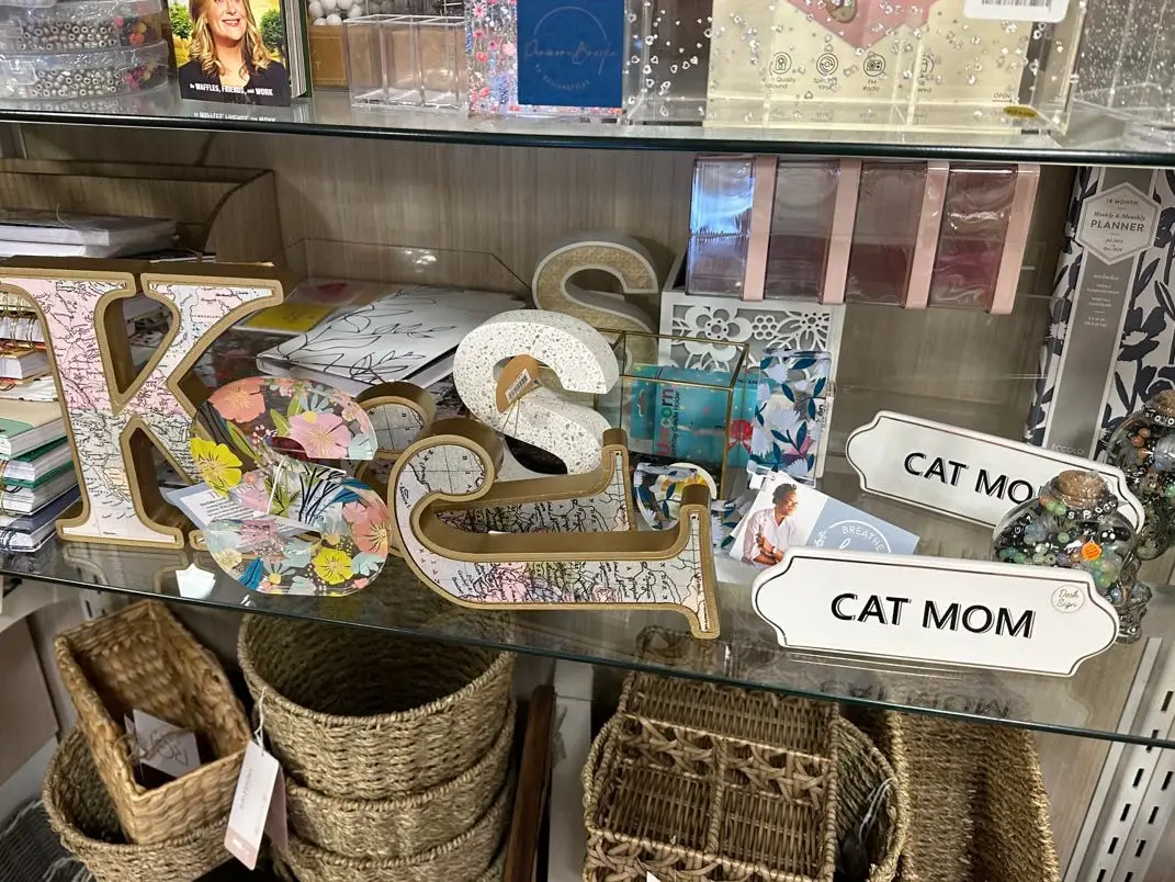 Large letter decor with maps within them and desk signs on display in a HomeGoods