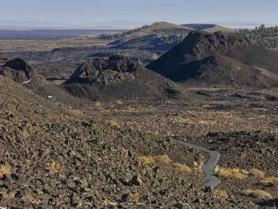 A landscape of black rock and hills.