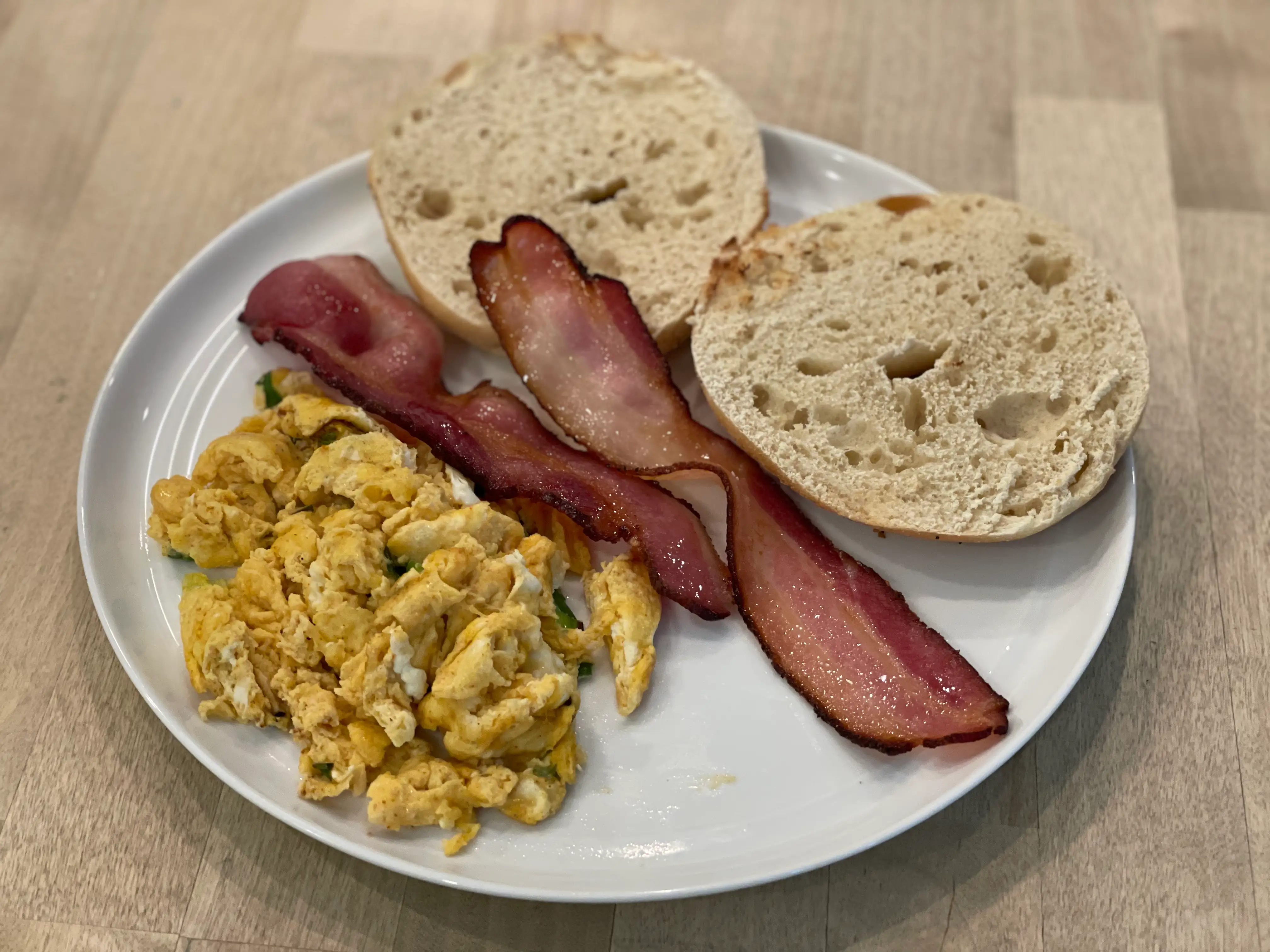 eggs bacon and a bagel on a plate