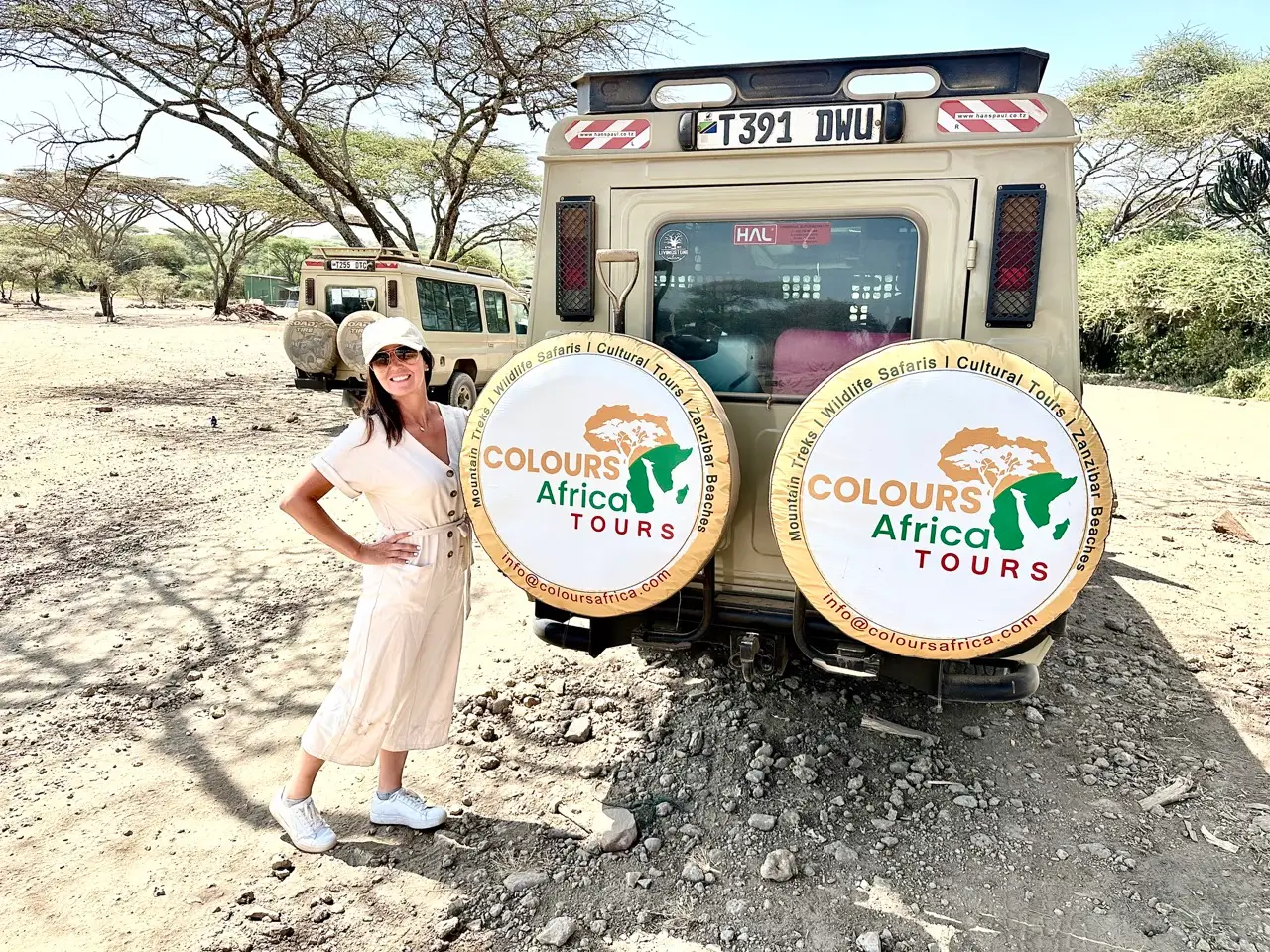Author Jackie Longo with her Colours of Africa tour guide's Land Cruiser in Tanzania, Africa