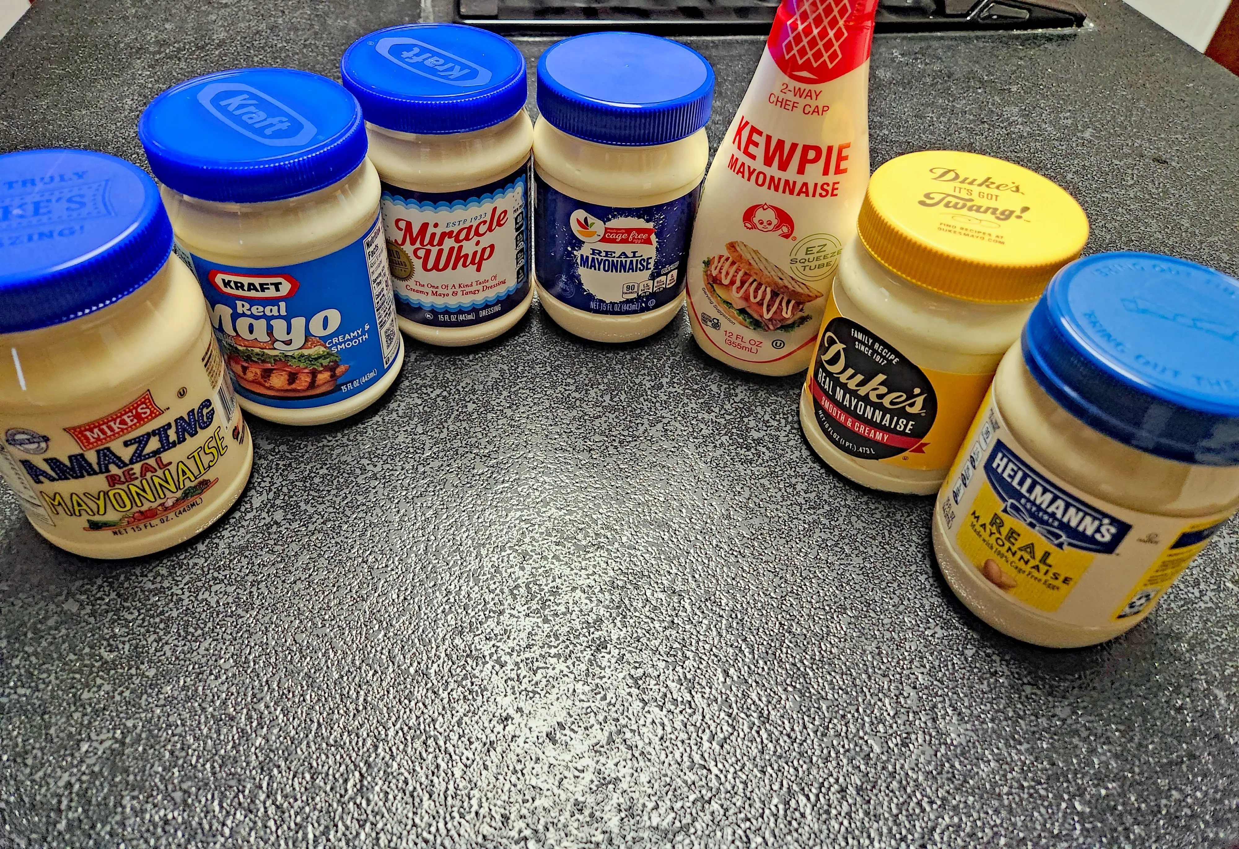 seven jars of mayonnaise on a counter