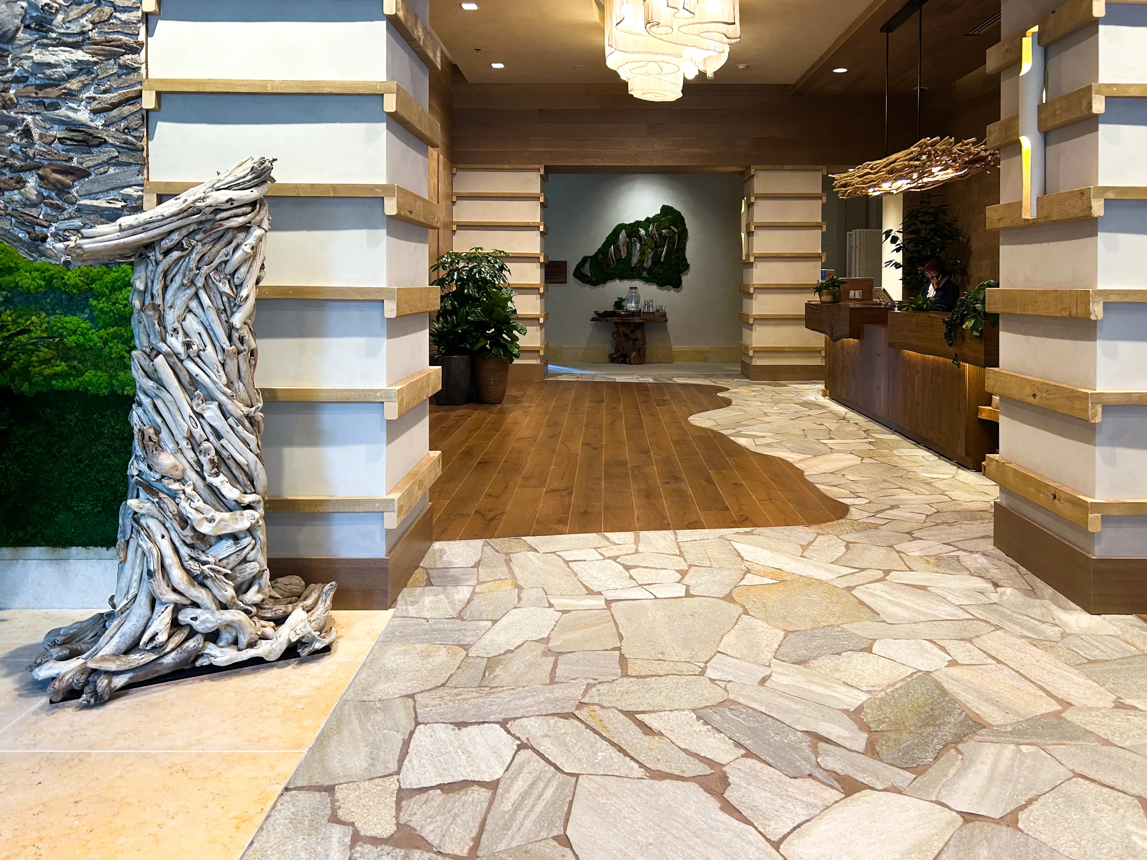 The entrance to the 1 Hotel Seattle lobby with a sculpture of a No. 1 made of driftwood.