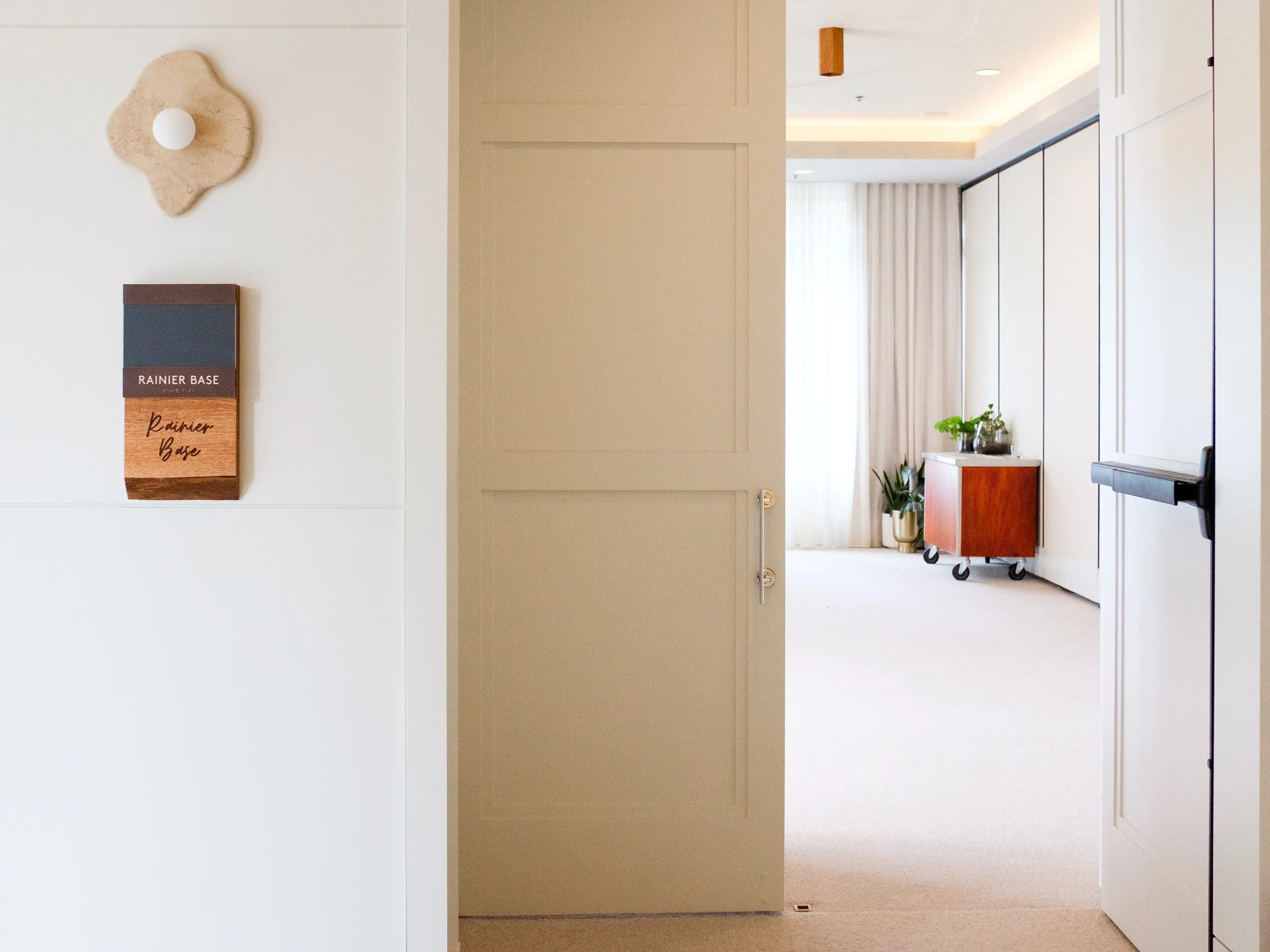 The entrance to a white meeting room inside 1 Hotel Seattle