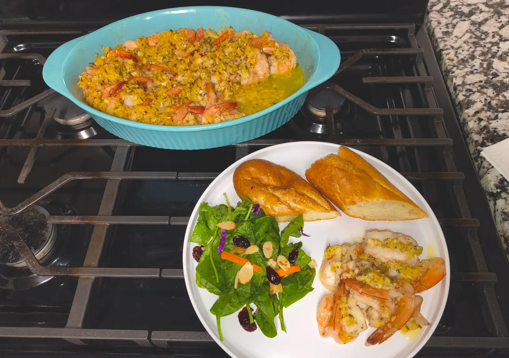 Ina Garten's shrimp scampi plated with salad and bread.