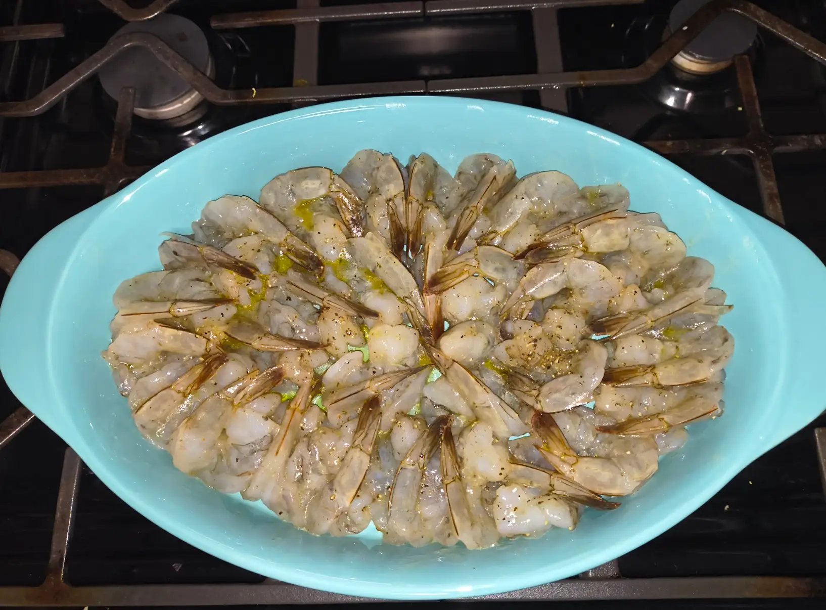 Arranging shrimp in a bowl for baked shrimp scampi.