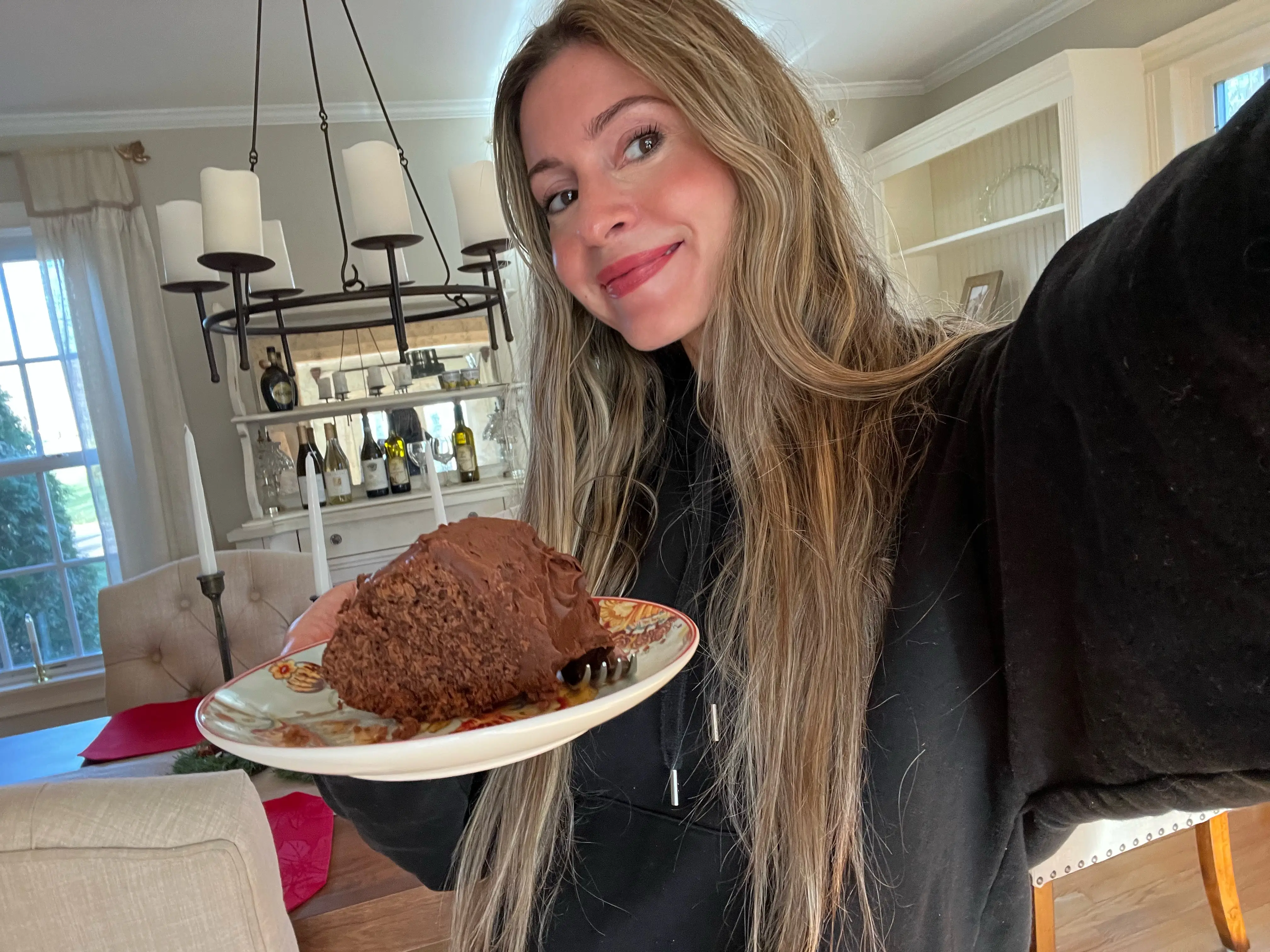 The author posing with a slice of chocolate cola cake.