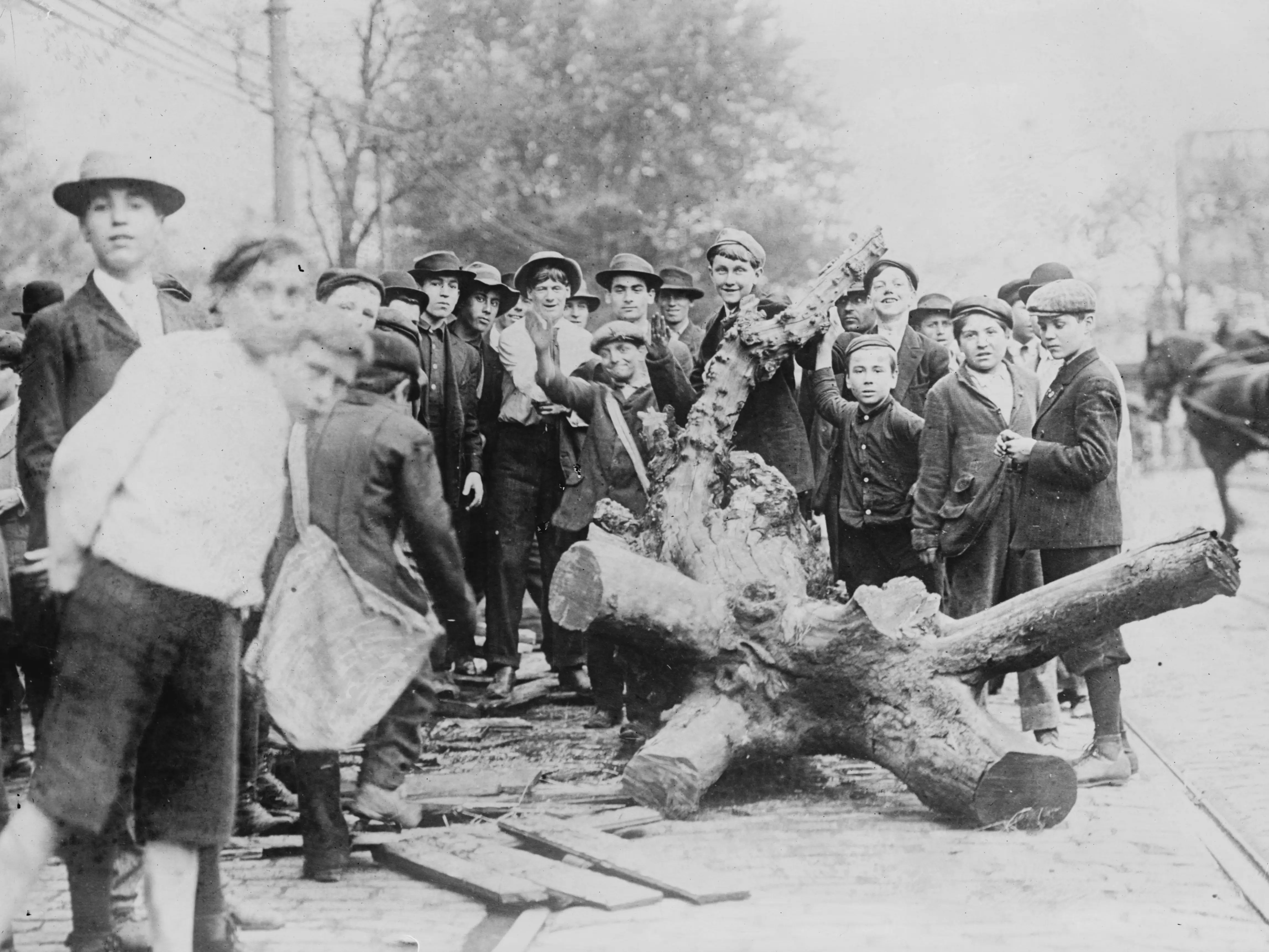 Men and boys gather around strike obstructions set up during the Cleveland Car Strike, on 119th Street, Ohio, 1899