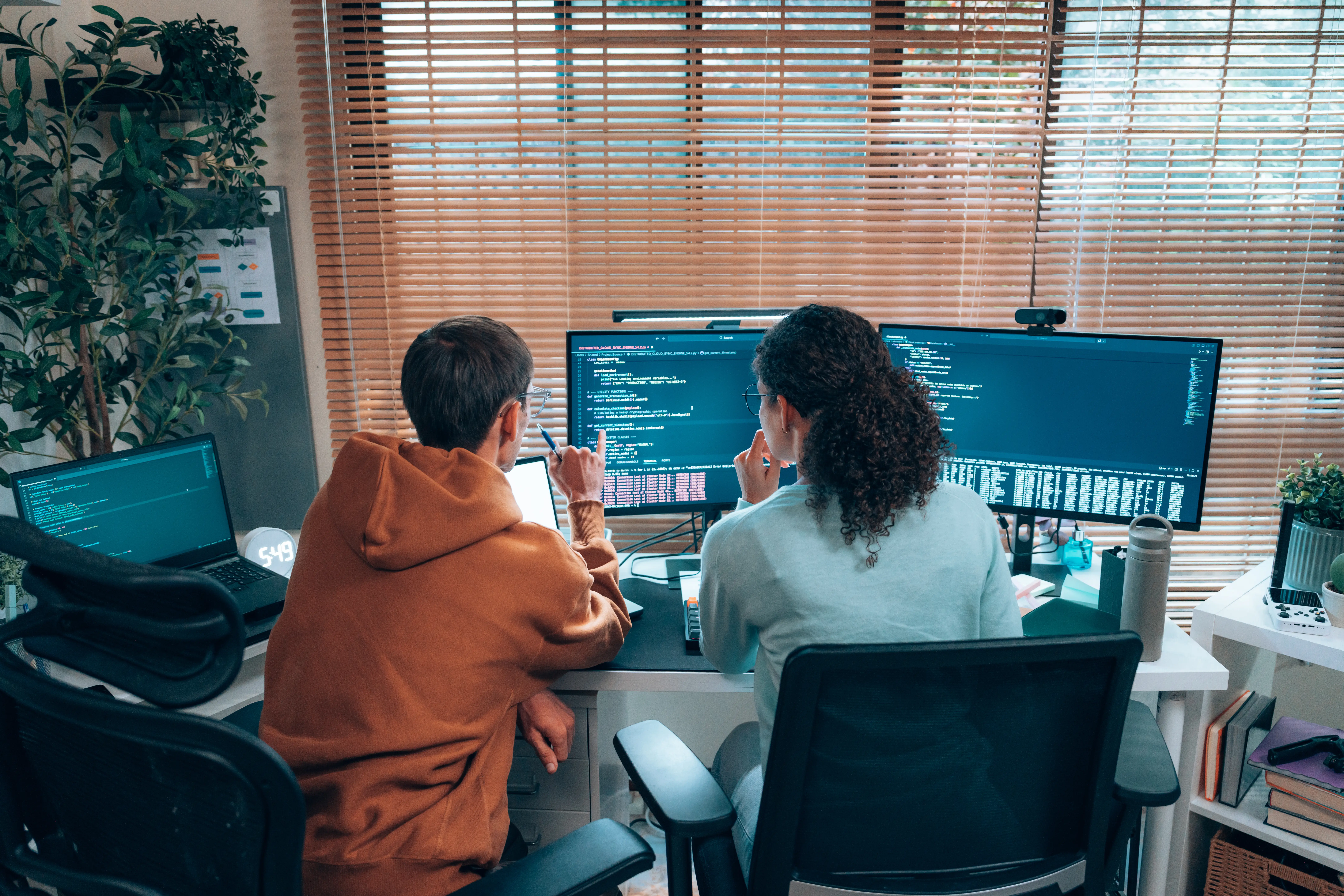 Two tech employees working at a desk