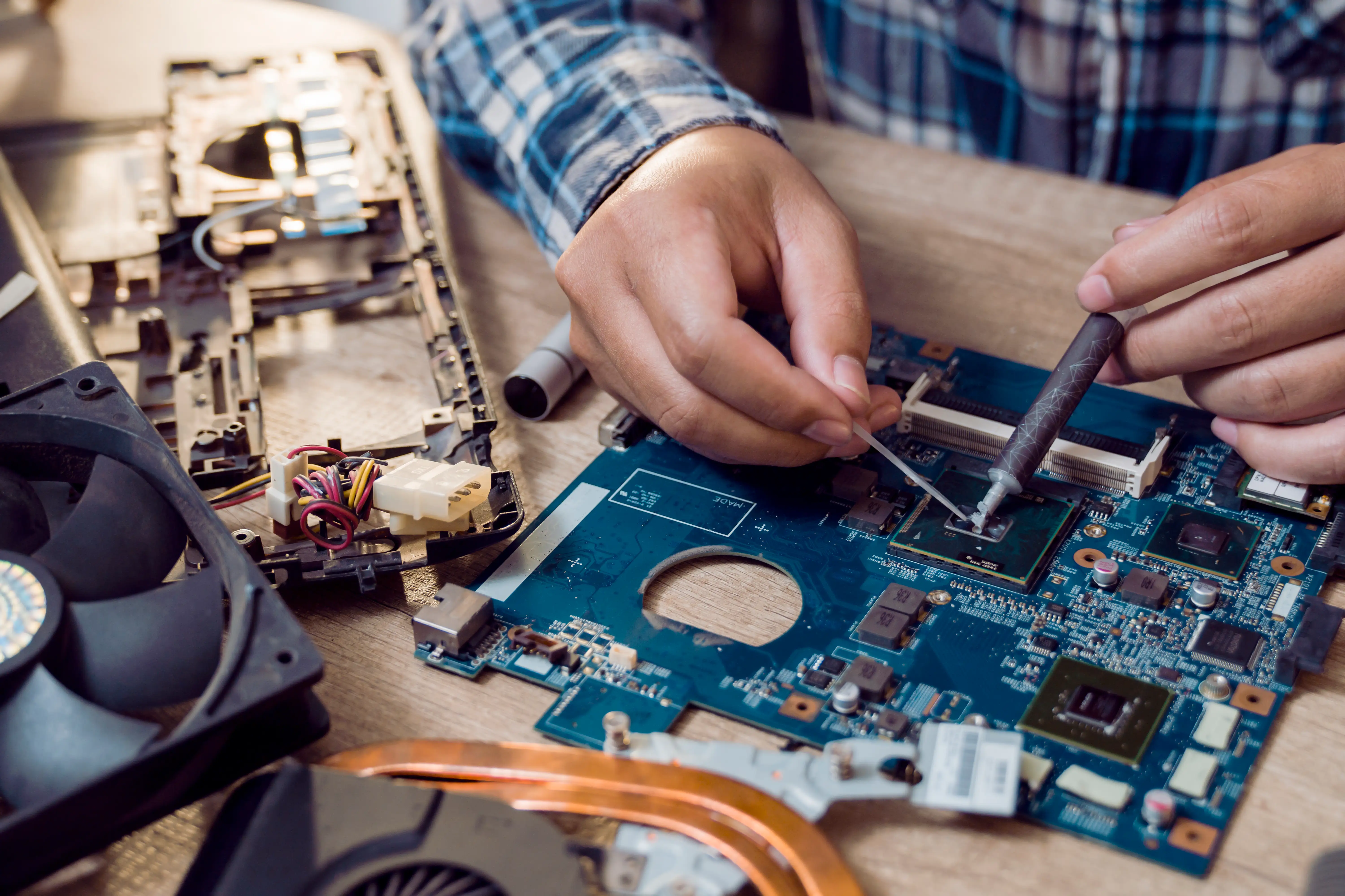 Close-up of someone soldering a computer chip