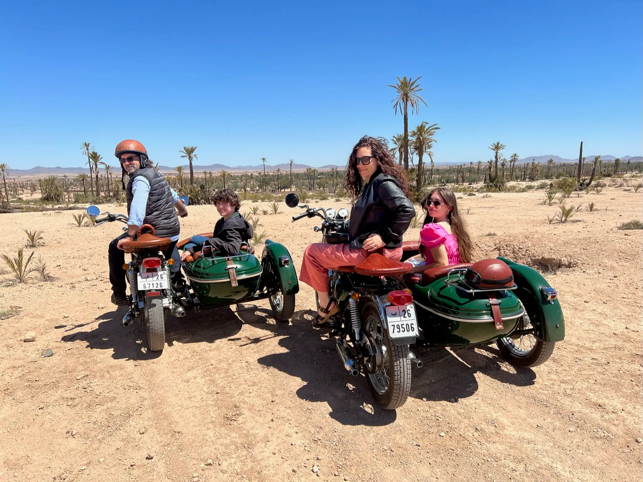 Family riding bikes with sidecars