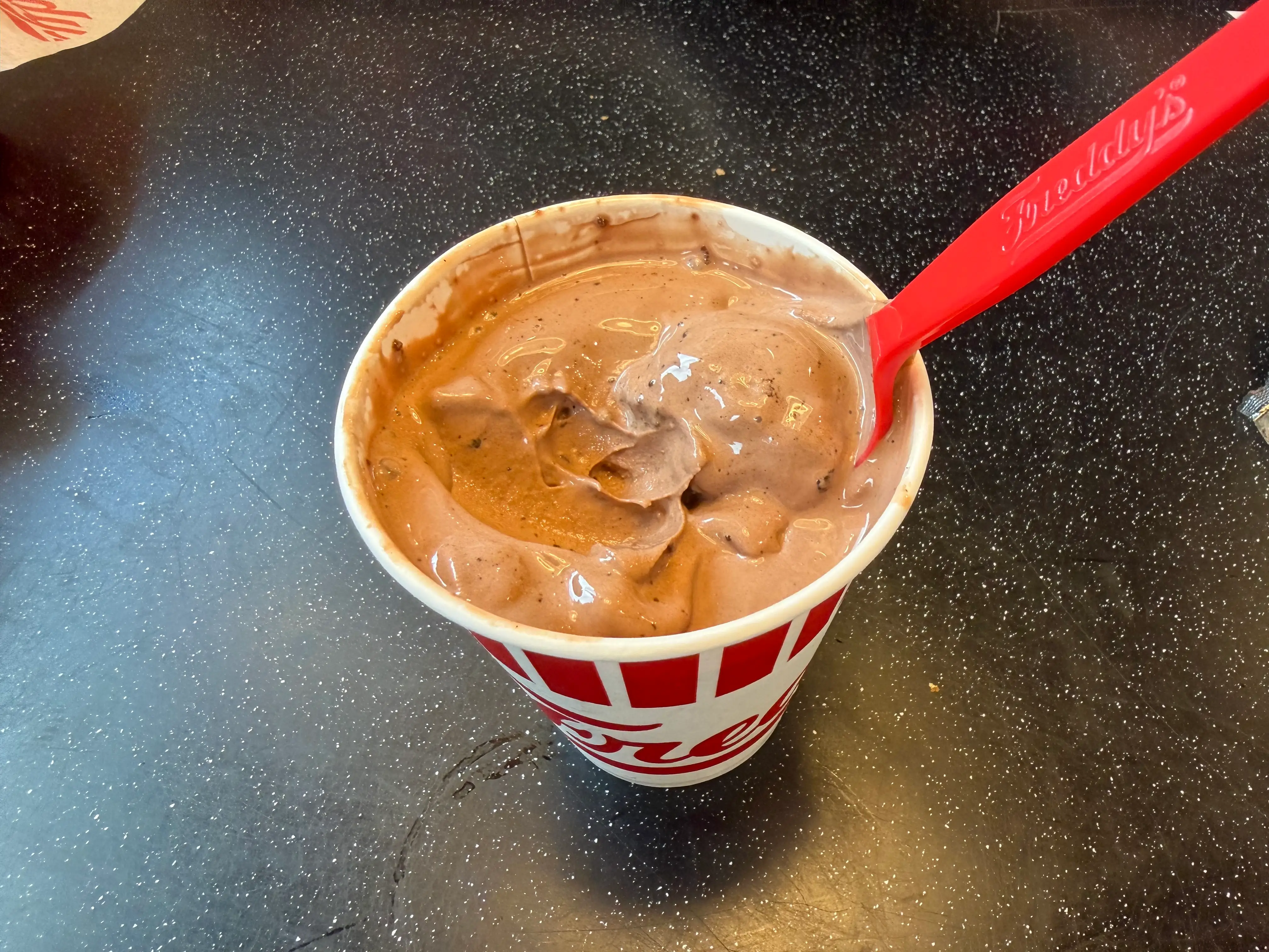 Aerial view of a chocolate concrete at Ferry's with spoon in it