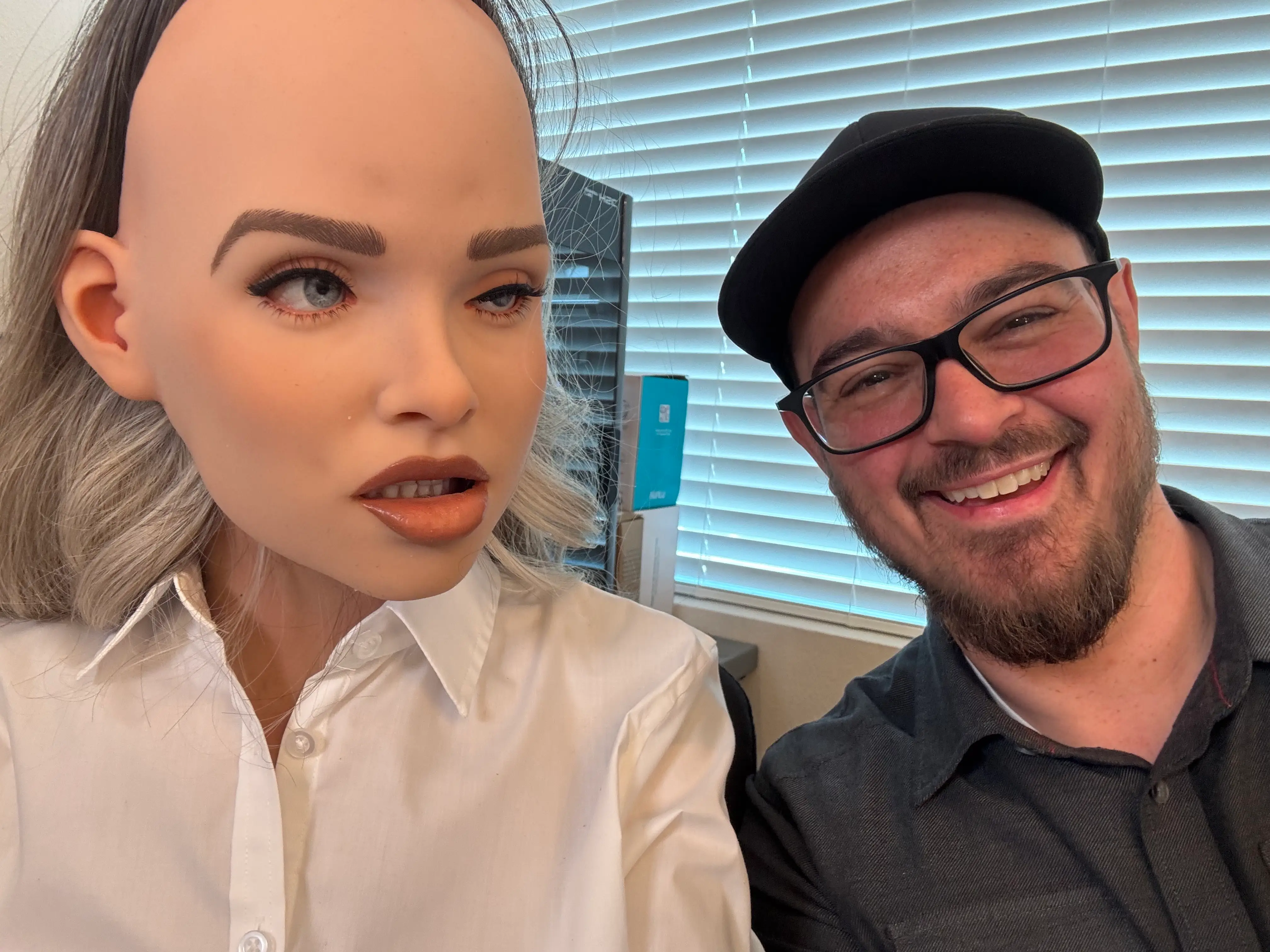 Dan Allen Business Insider producer next to humanoid robot.