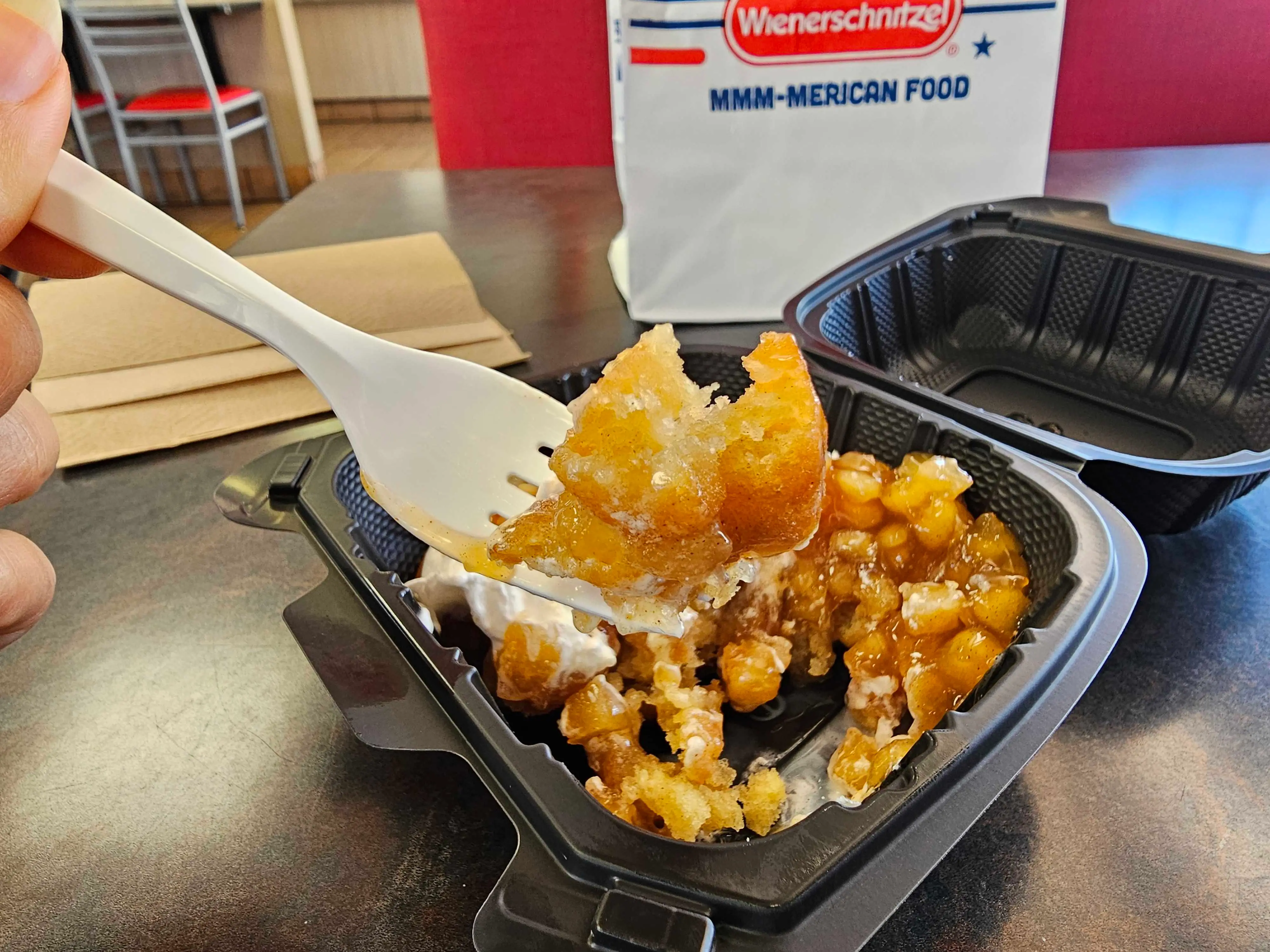 A forkful of an apple pie funnel cake from Wienerschnitzel.
