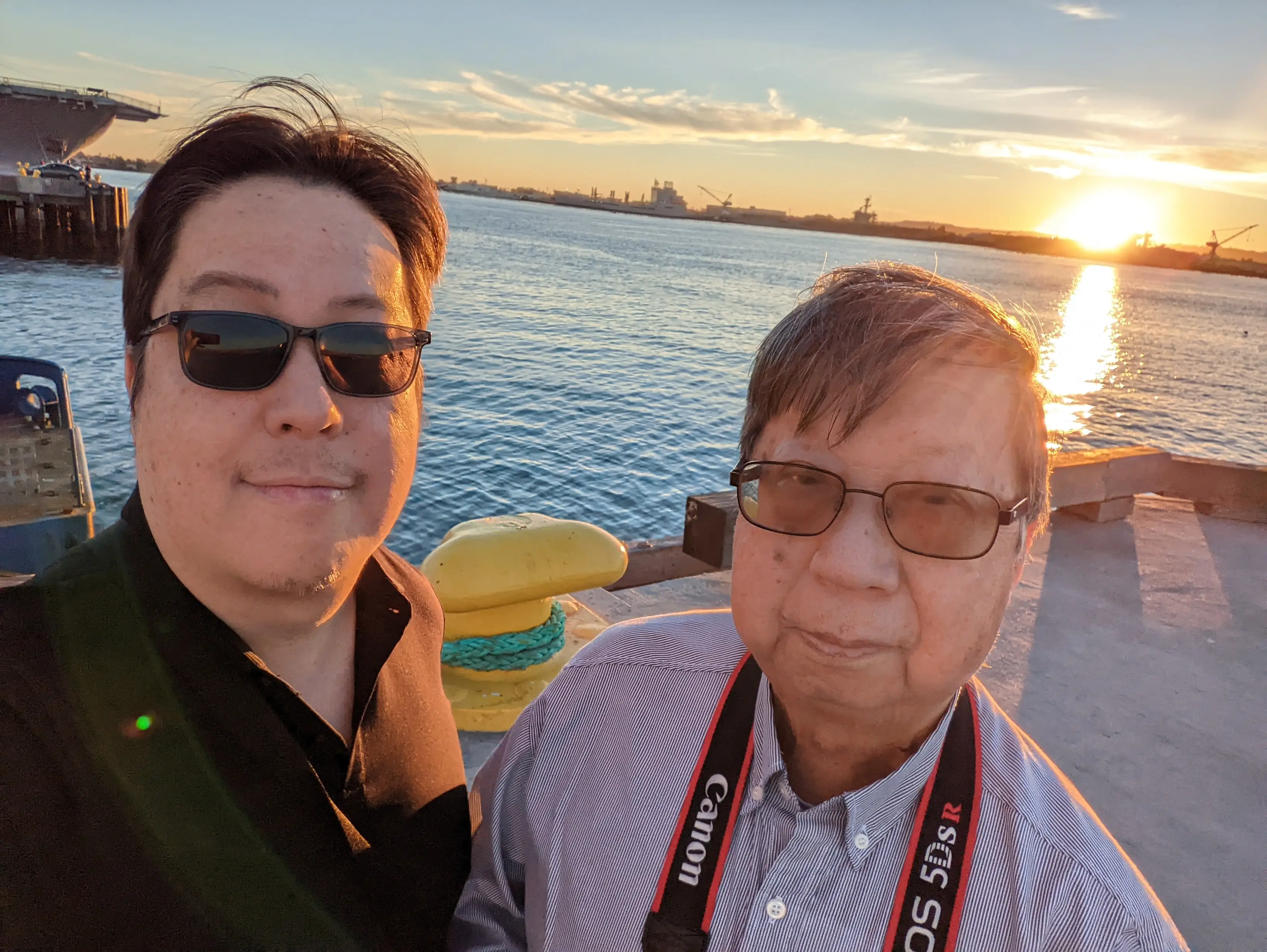 Dad and son posing with sunset