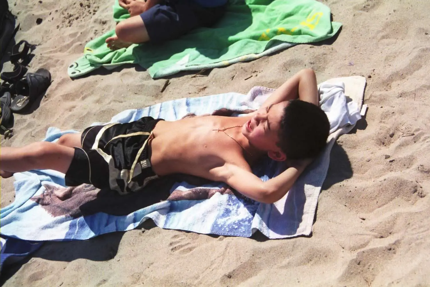 Boy tanning at beach