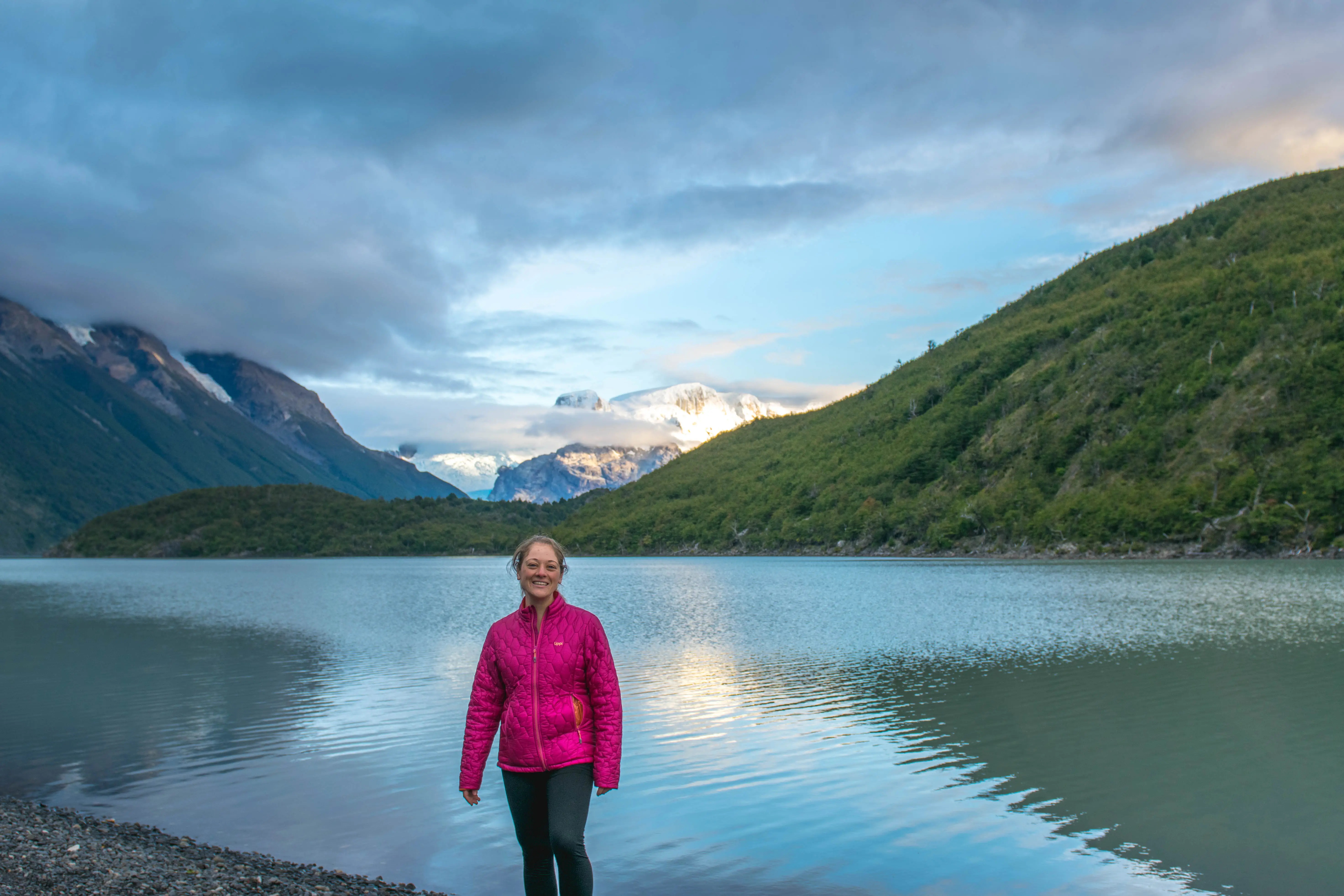 Woman smiling in front of water, mountains in Chile