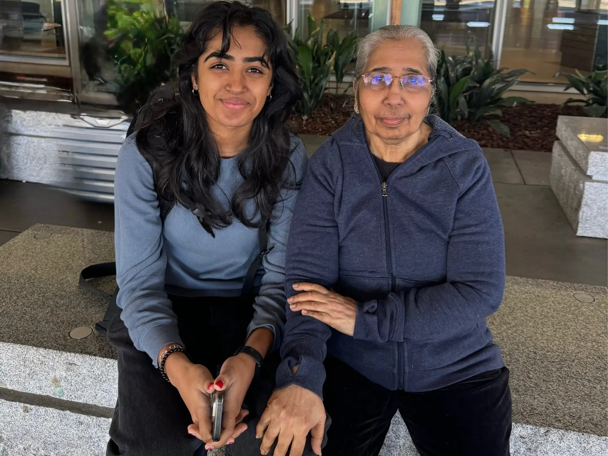 College age woman and grandmother posing for photo