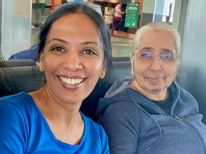 mother and daughter posing for photo