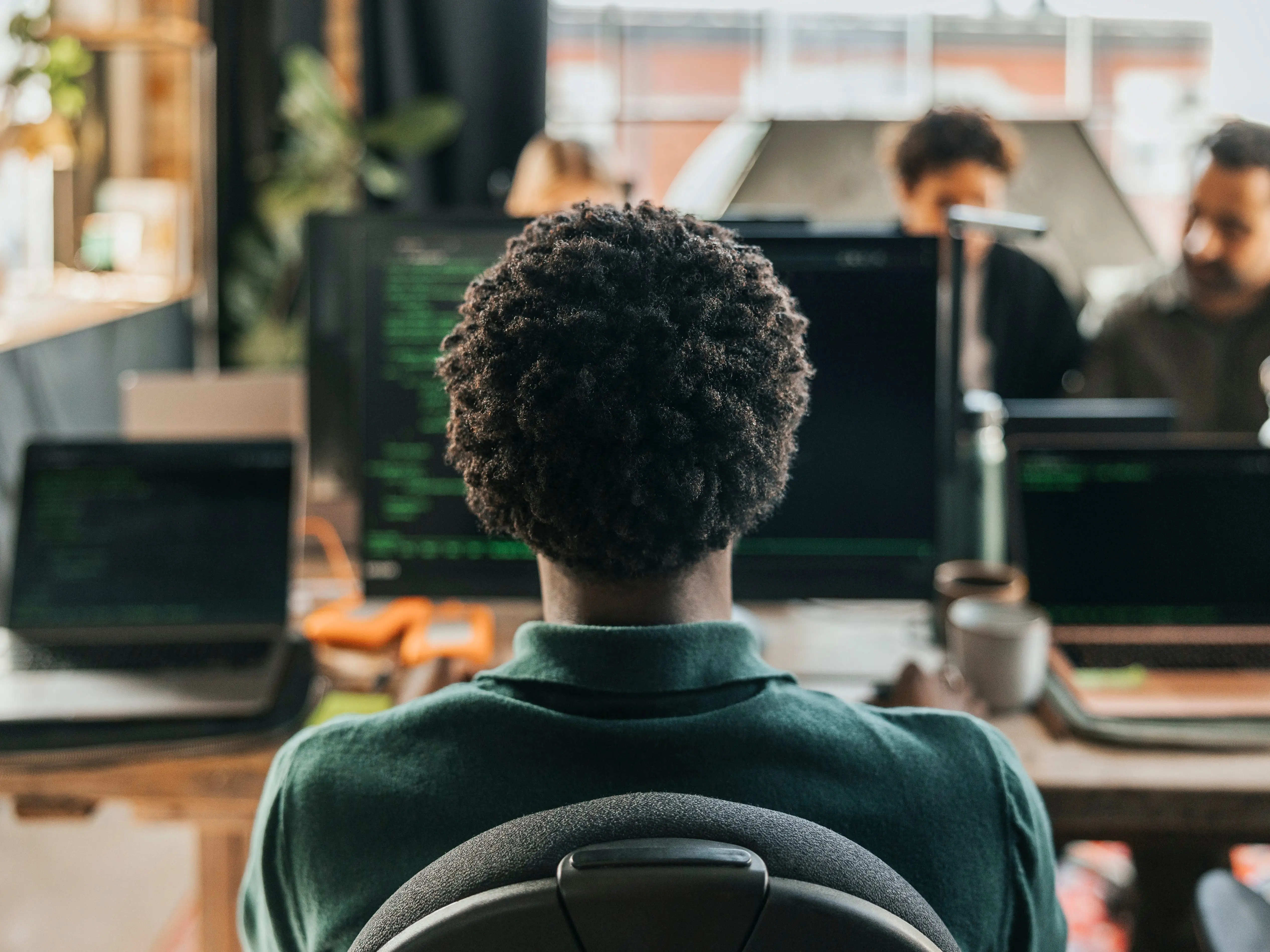 worker back to camera at desk