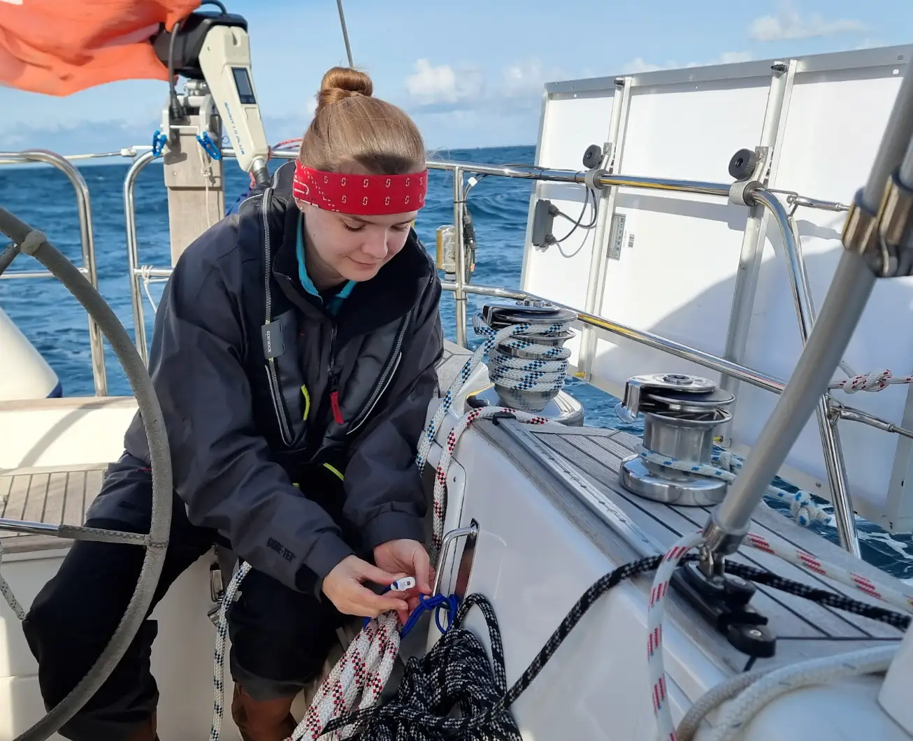 The writer wearing a bandana and using ropes to dock her boat.