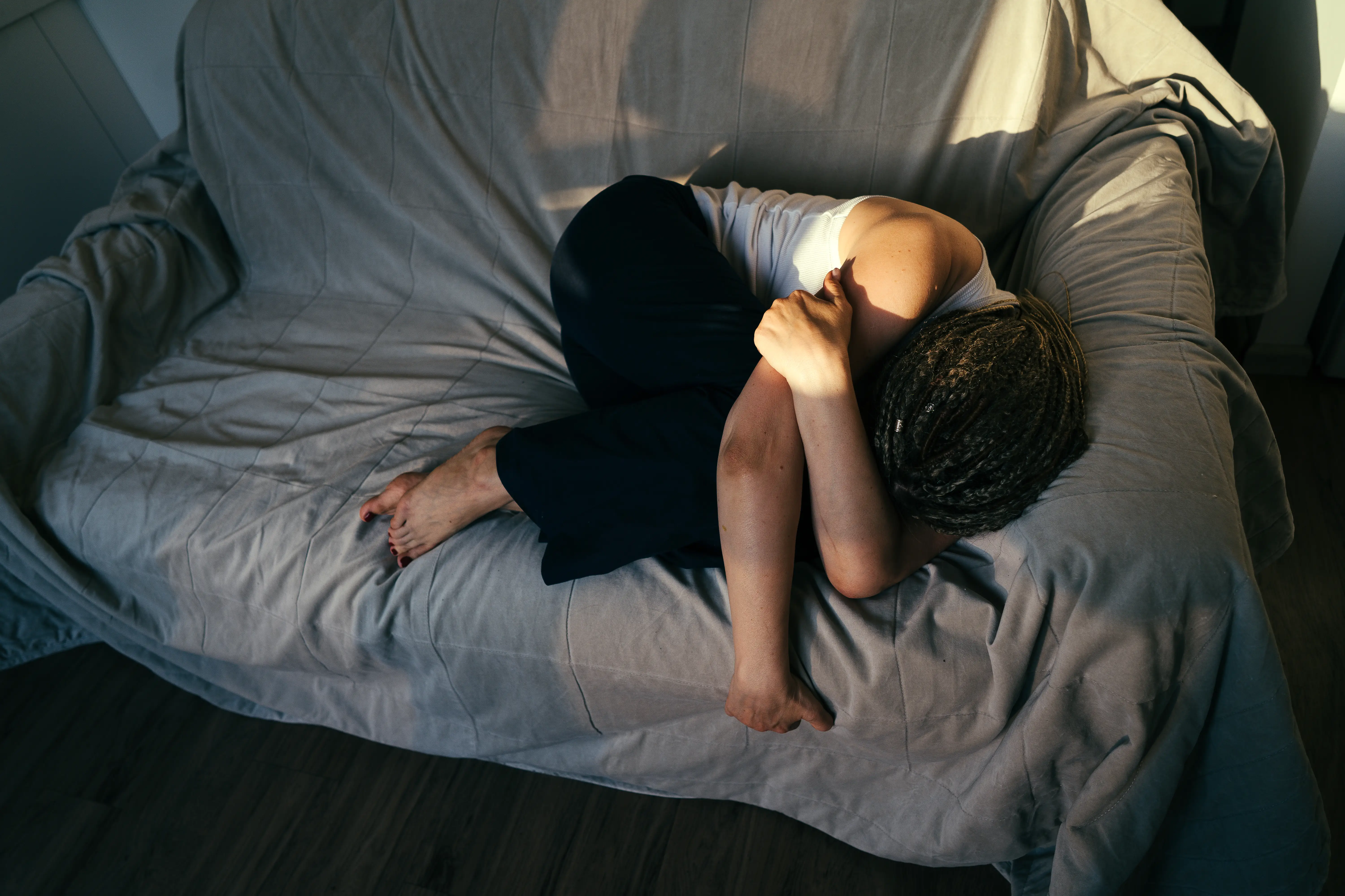 Woman on couch crying