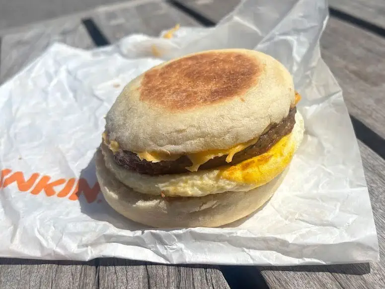 A sausage, egg, and cheese sandwich on an English muffin.