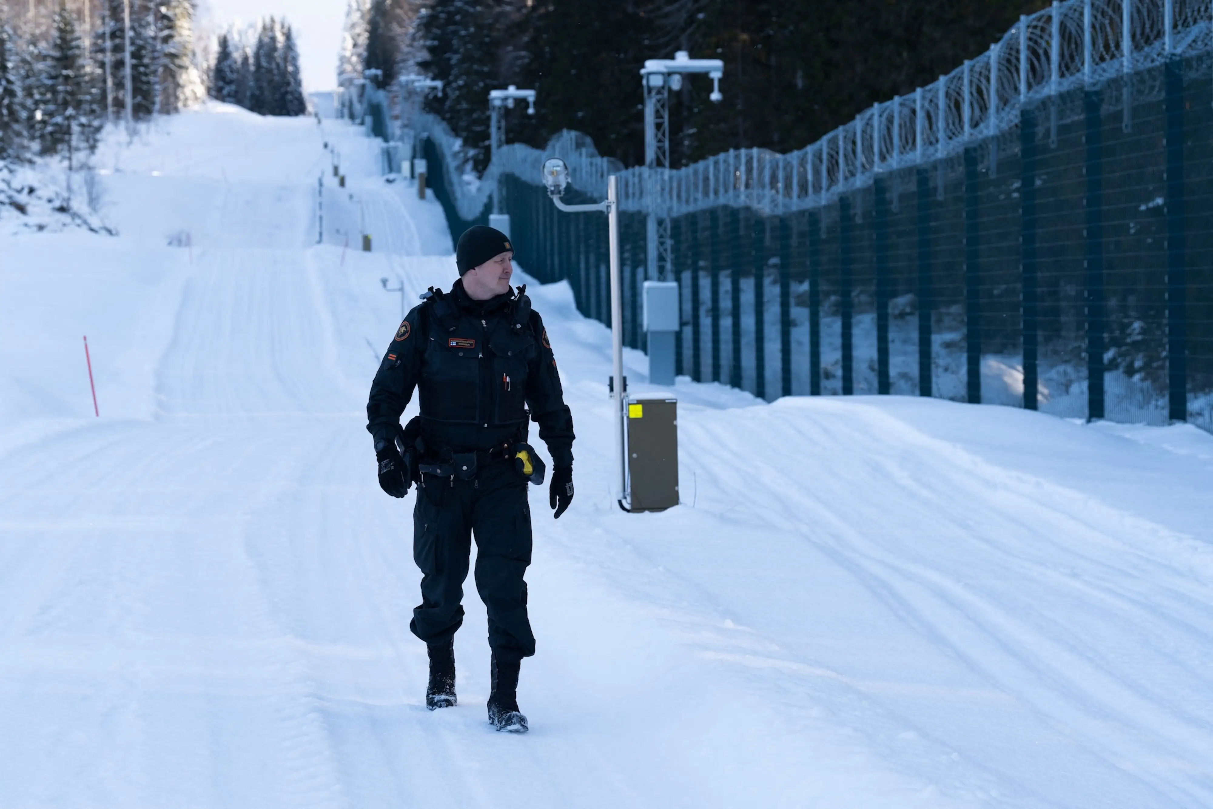 A guard patrols the newly built fence along the Russia-Finland border in Finland's North Karelia region.