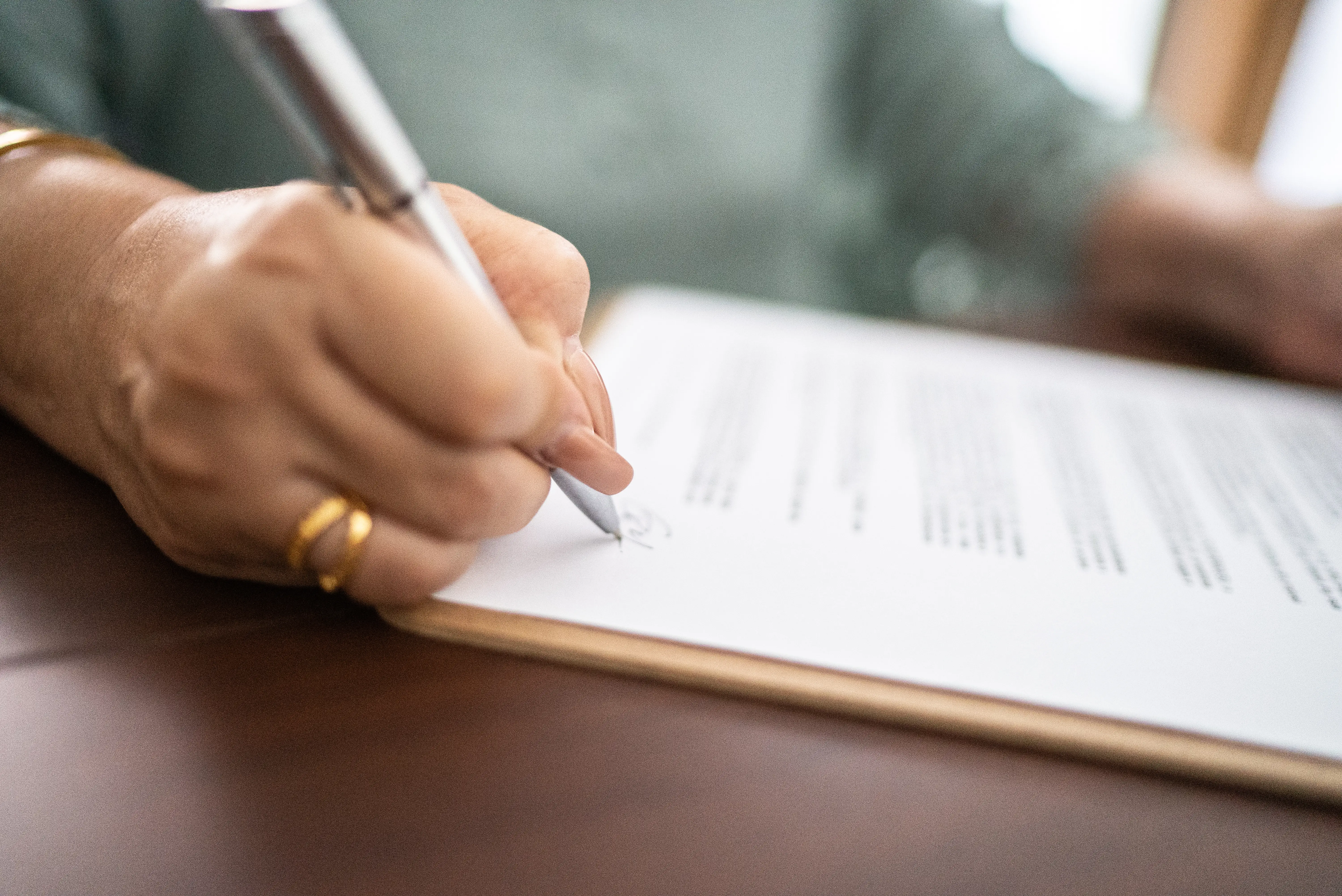 Woman signing a document