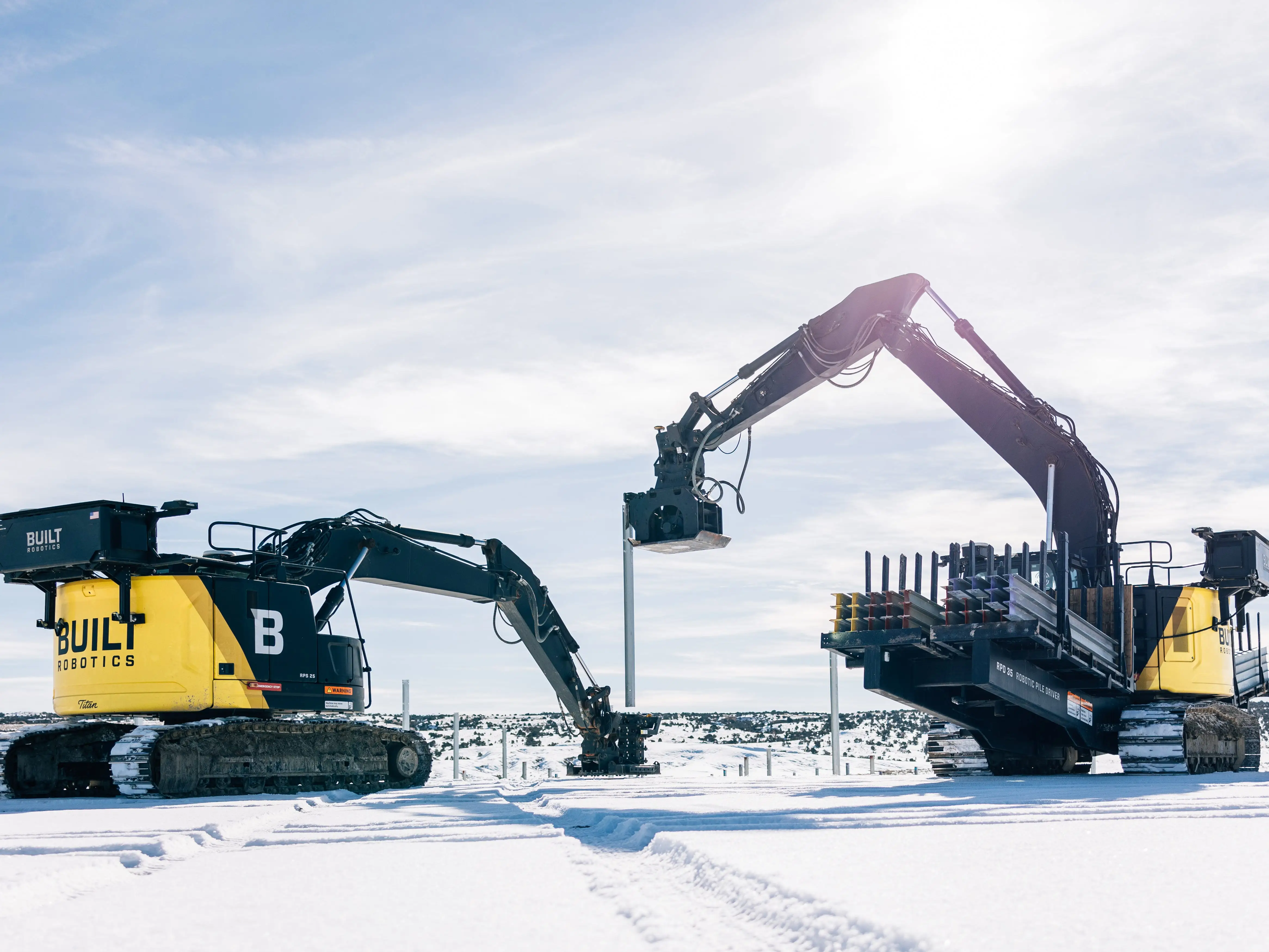 Two heavy machinery pile driving