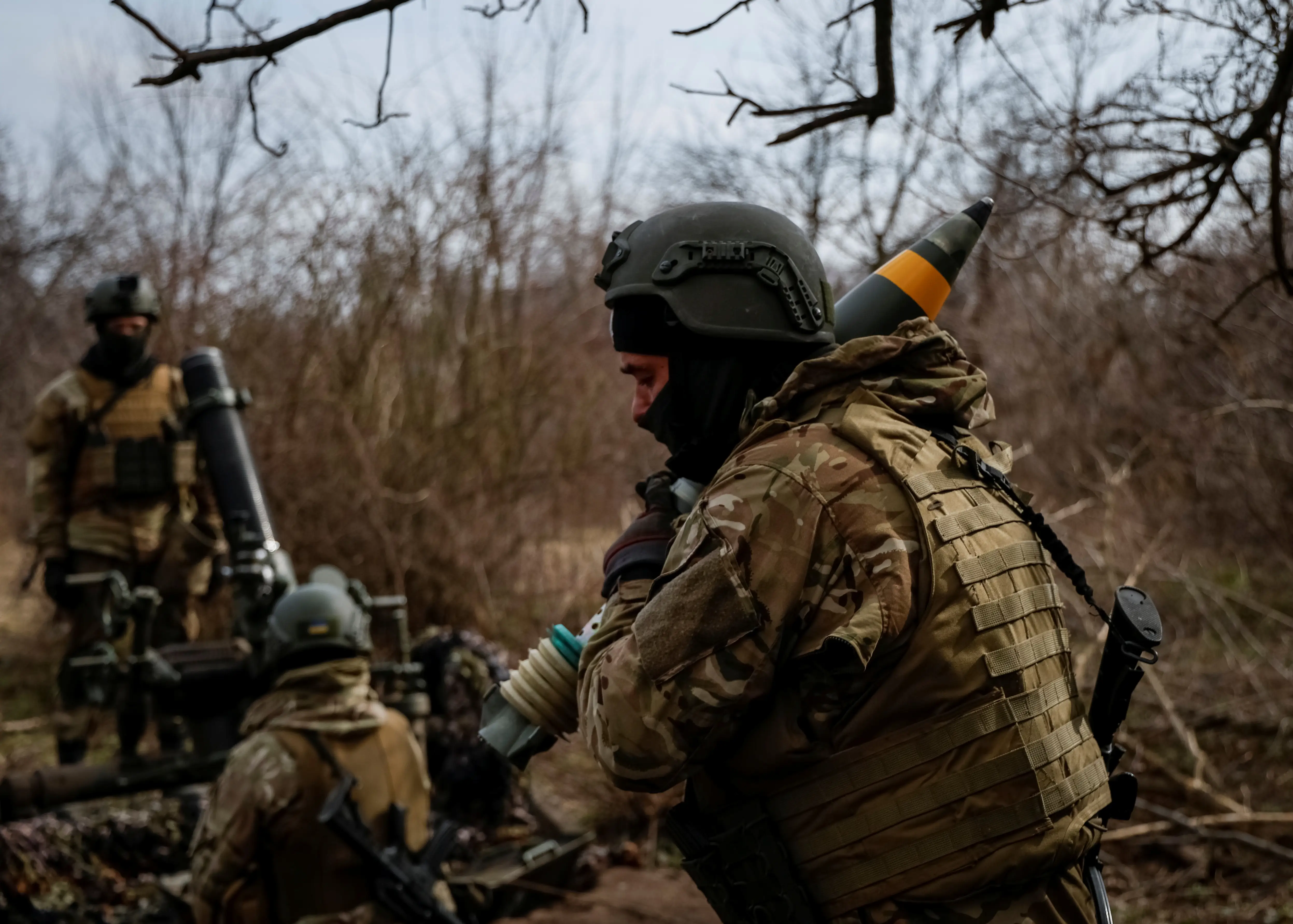 Service members with the Freedom of Russia Legion under the Ukrainian Army prepare to fire a mortar at a Russian military position, as Russia's invasion of Ukraine continues, in Donetsk region, Ukraine, March 21, 2023.