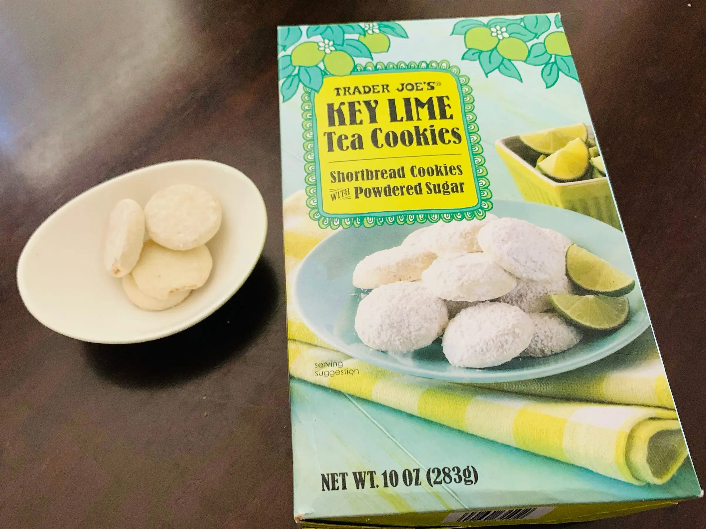 Trader Joe's key-lime tea cookies in a small white bowl next to the original packaging.