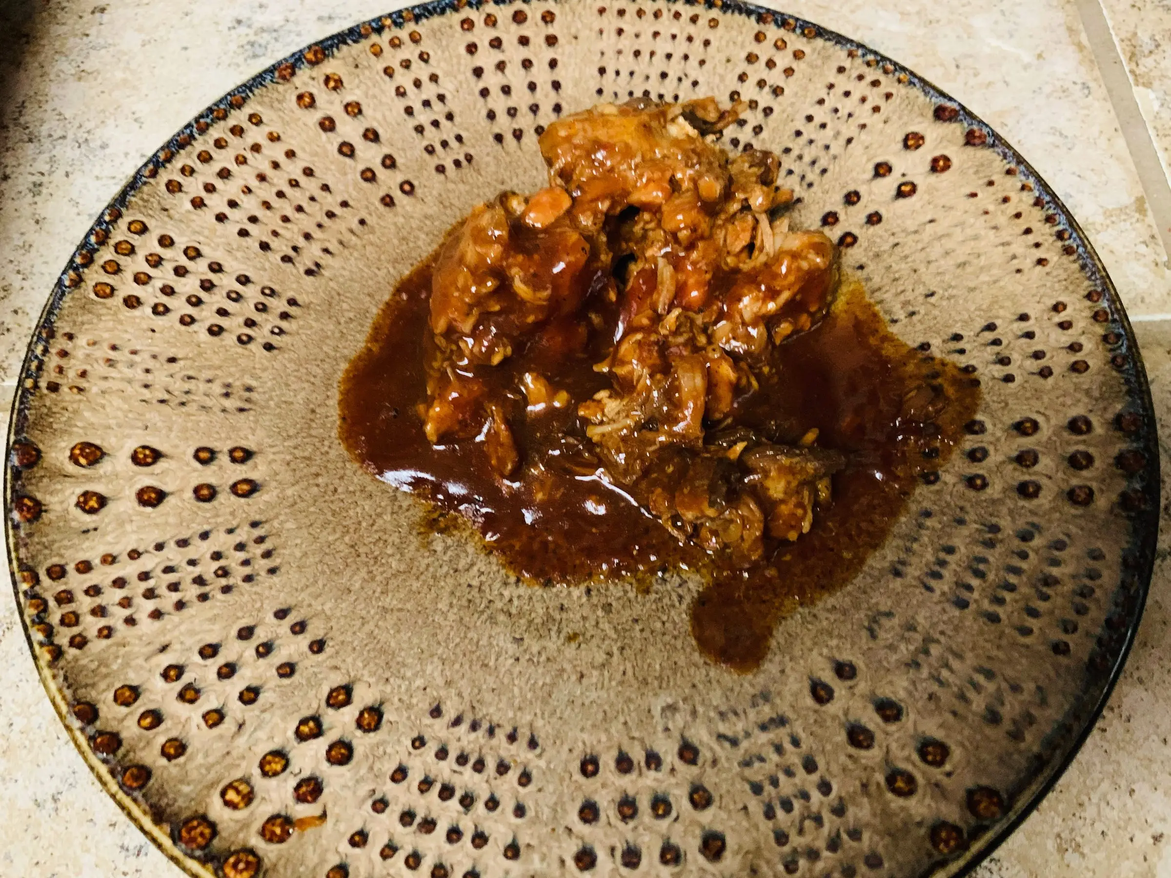 Trader Joe's pulled chicken in barbecue sauce on a plate.