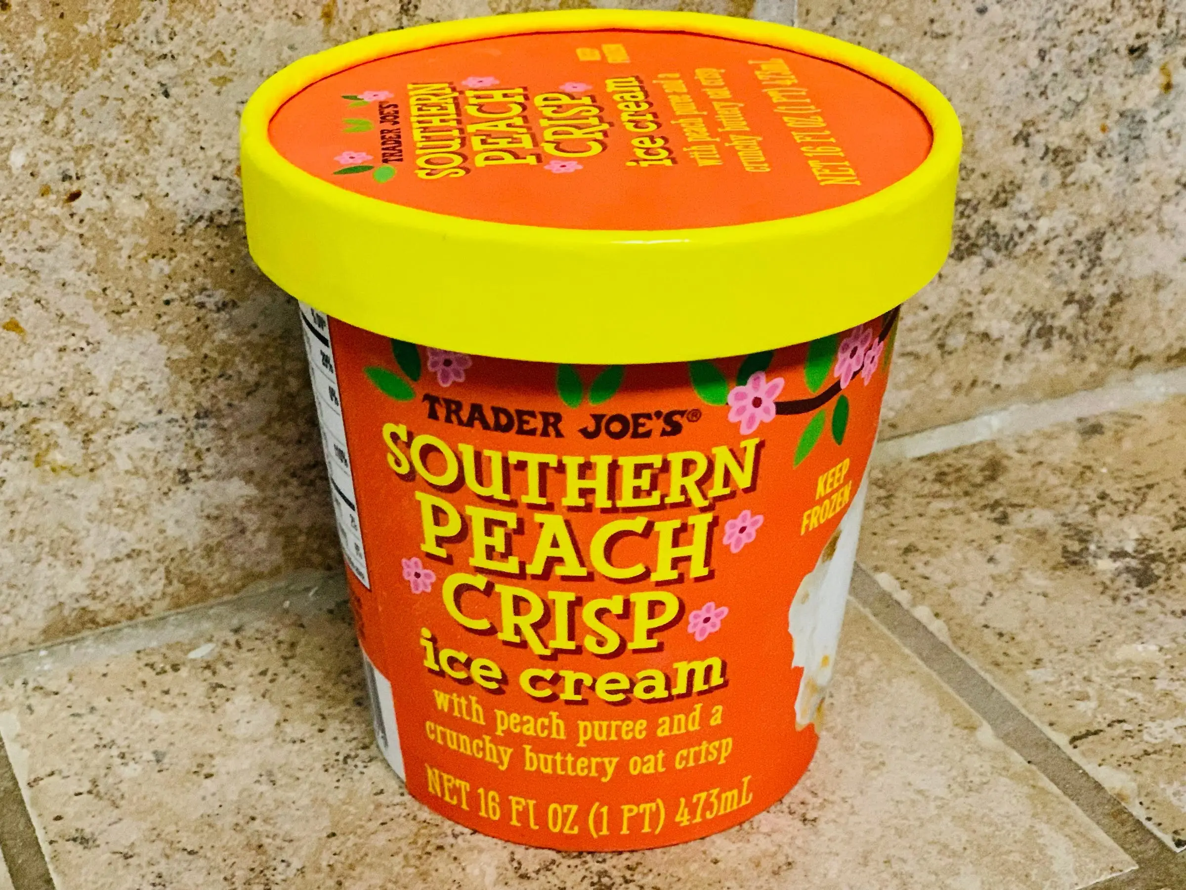 A container of Trader Joe's Southern peach crisp ice cream.