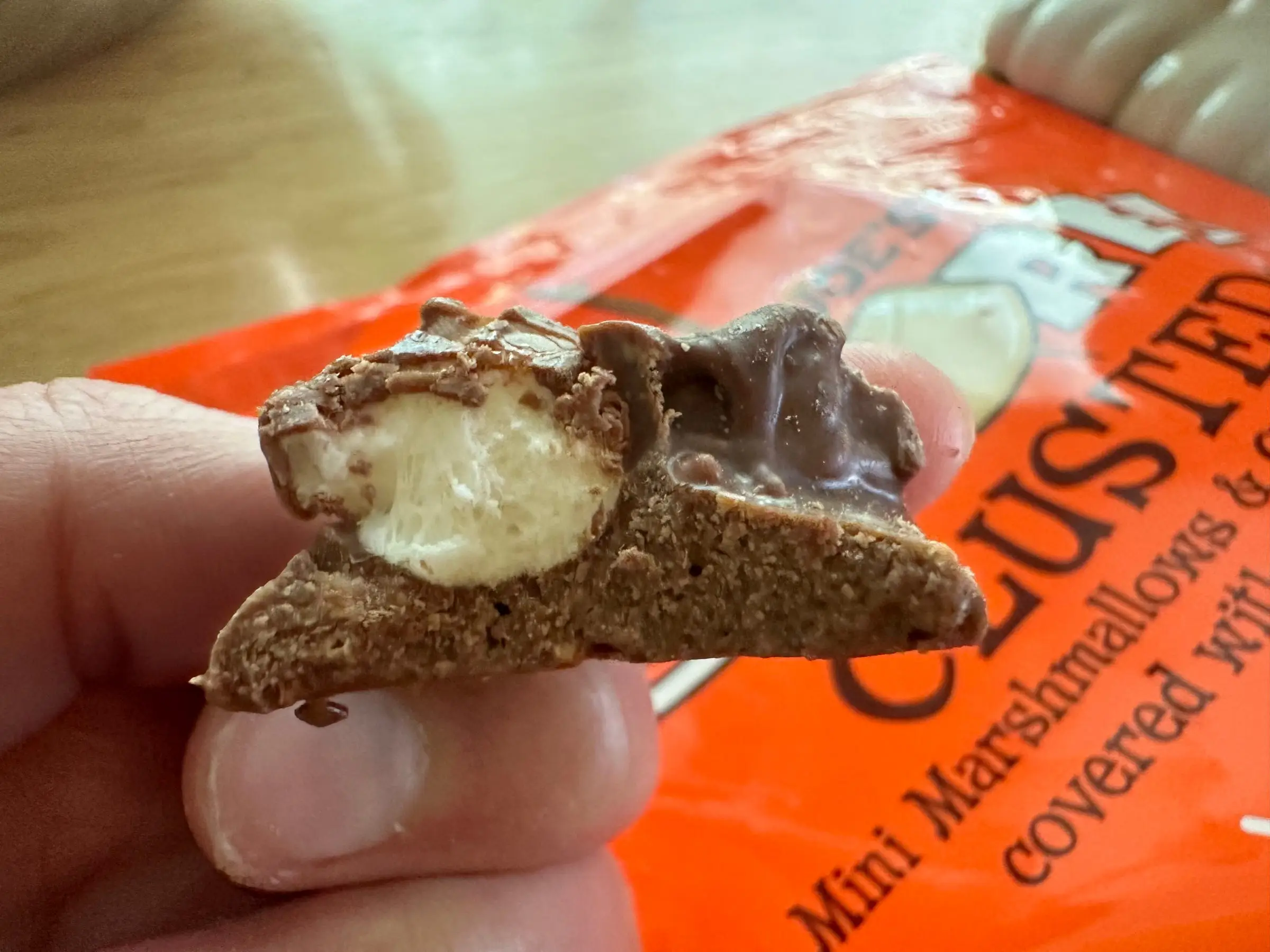 A Trader Joe's s'mores cluster cut open to show the mini marshmallow inside.