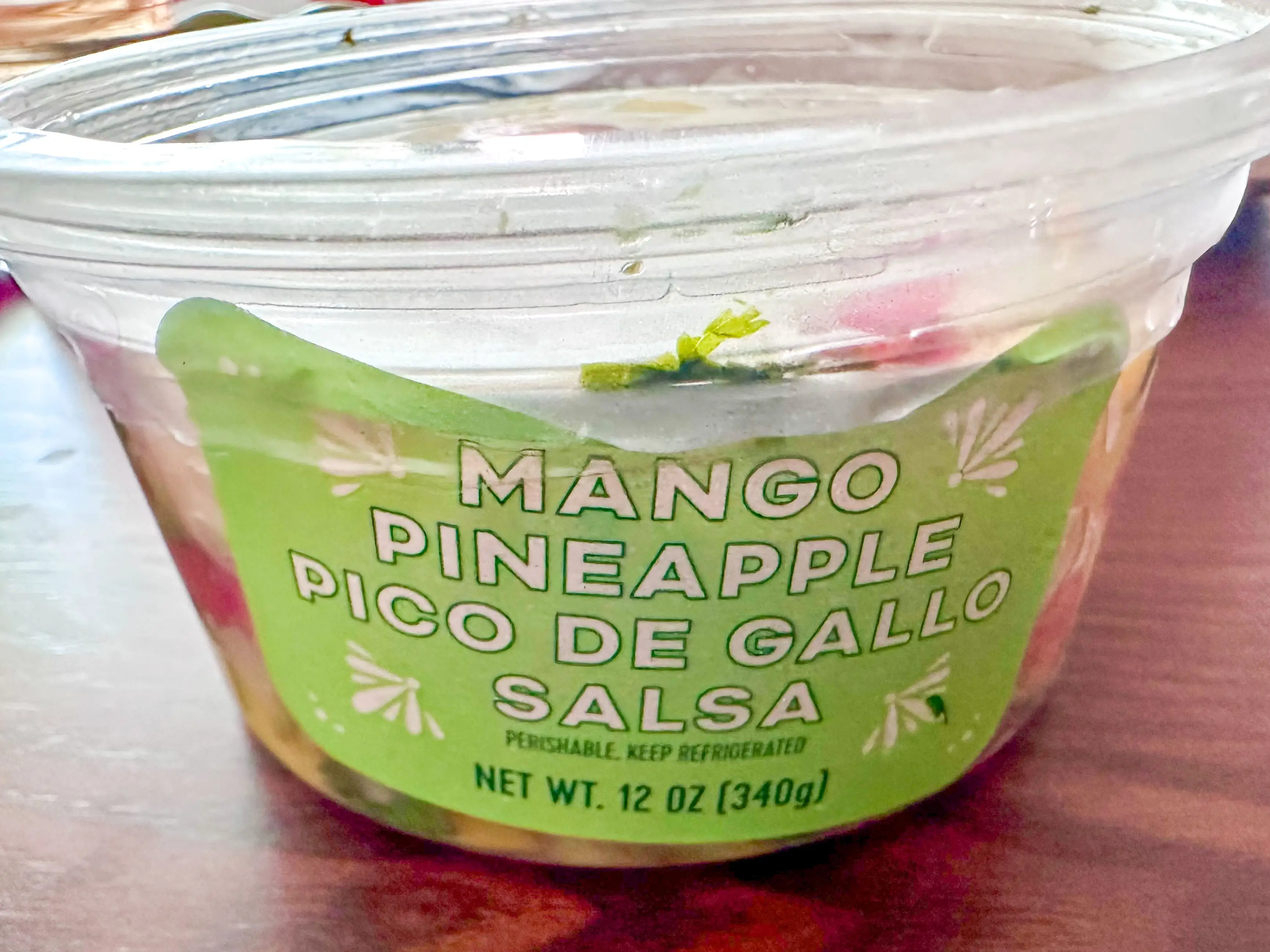 A container of Trader Joe's mango pineapple pico de gallo salsa.